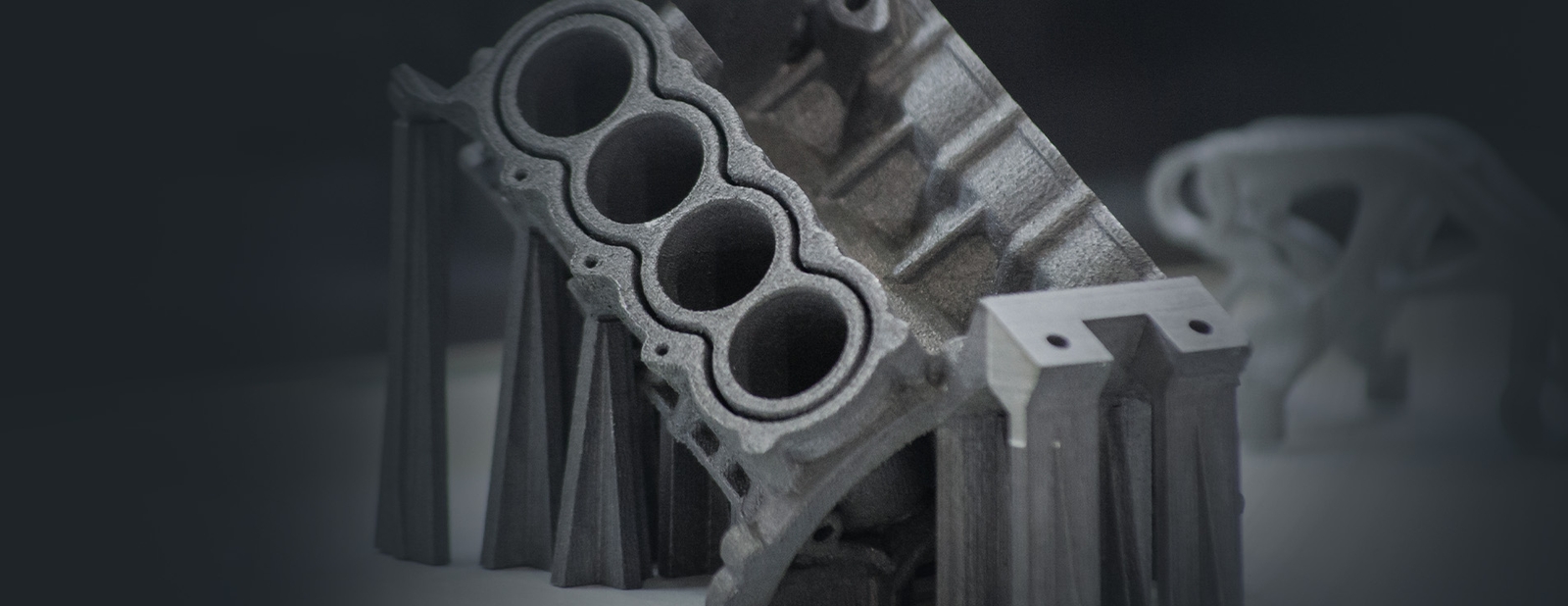 Metal 3D Printing Photo of a metal 3D printed engine block component with support structures still attached