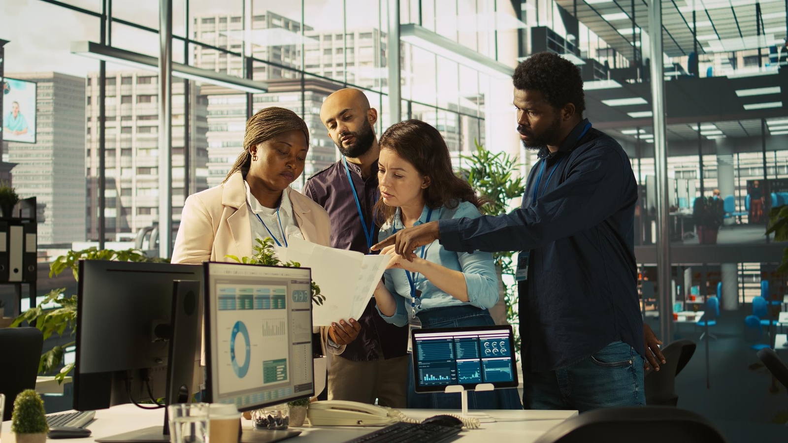 Photo of a team of professionals reviewing documents together in a modern office