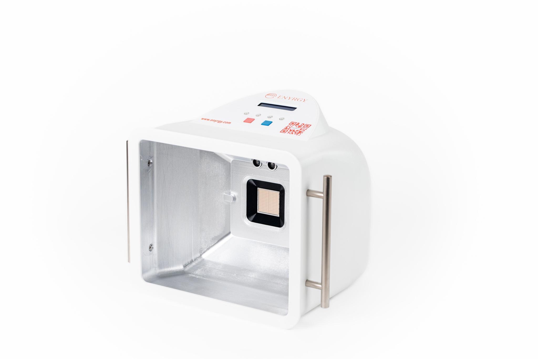 A white scientific device with an open, reflective interior containing a sensor, featuring a screen and buttons on top and a handle on the side.