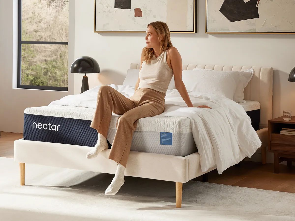 Woman sitting on edge of Nectar mattress