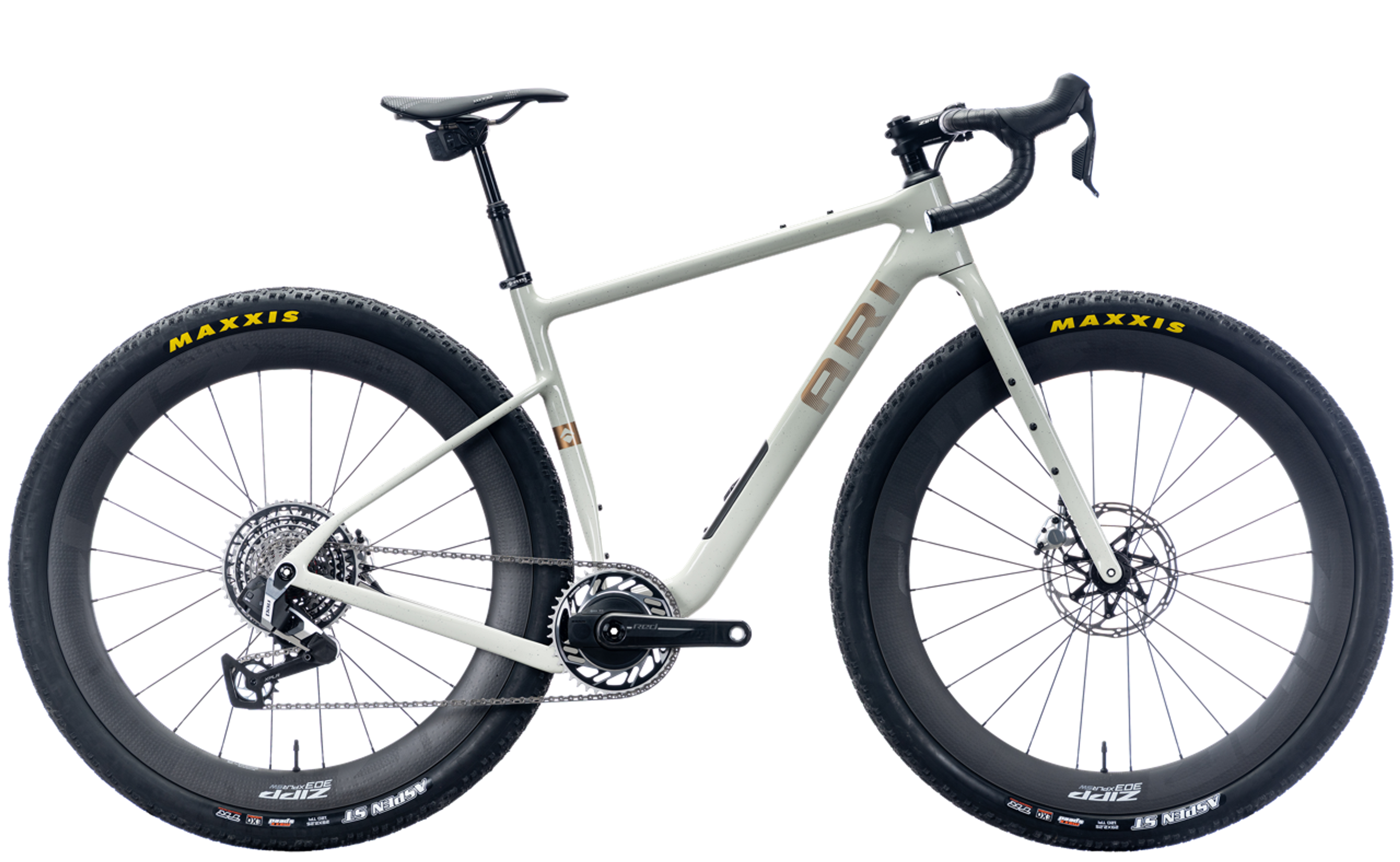 Light grey/tan gravel bike with drop handlebars and knobby tires on a white background.