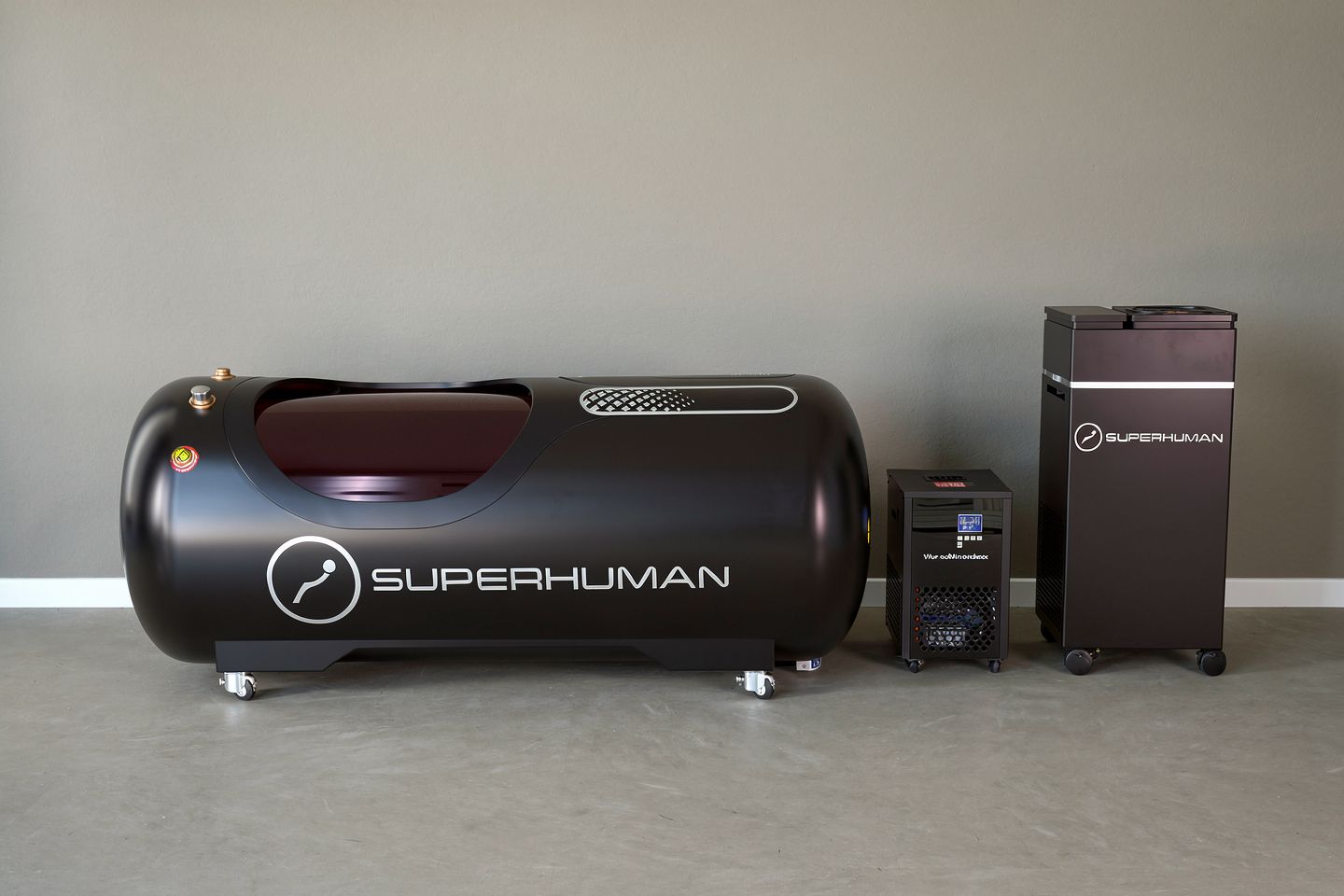 Black Superhuman hyperbaric chamber and two accompanying machines.