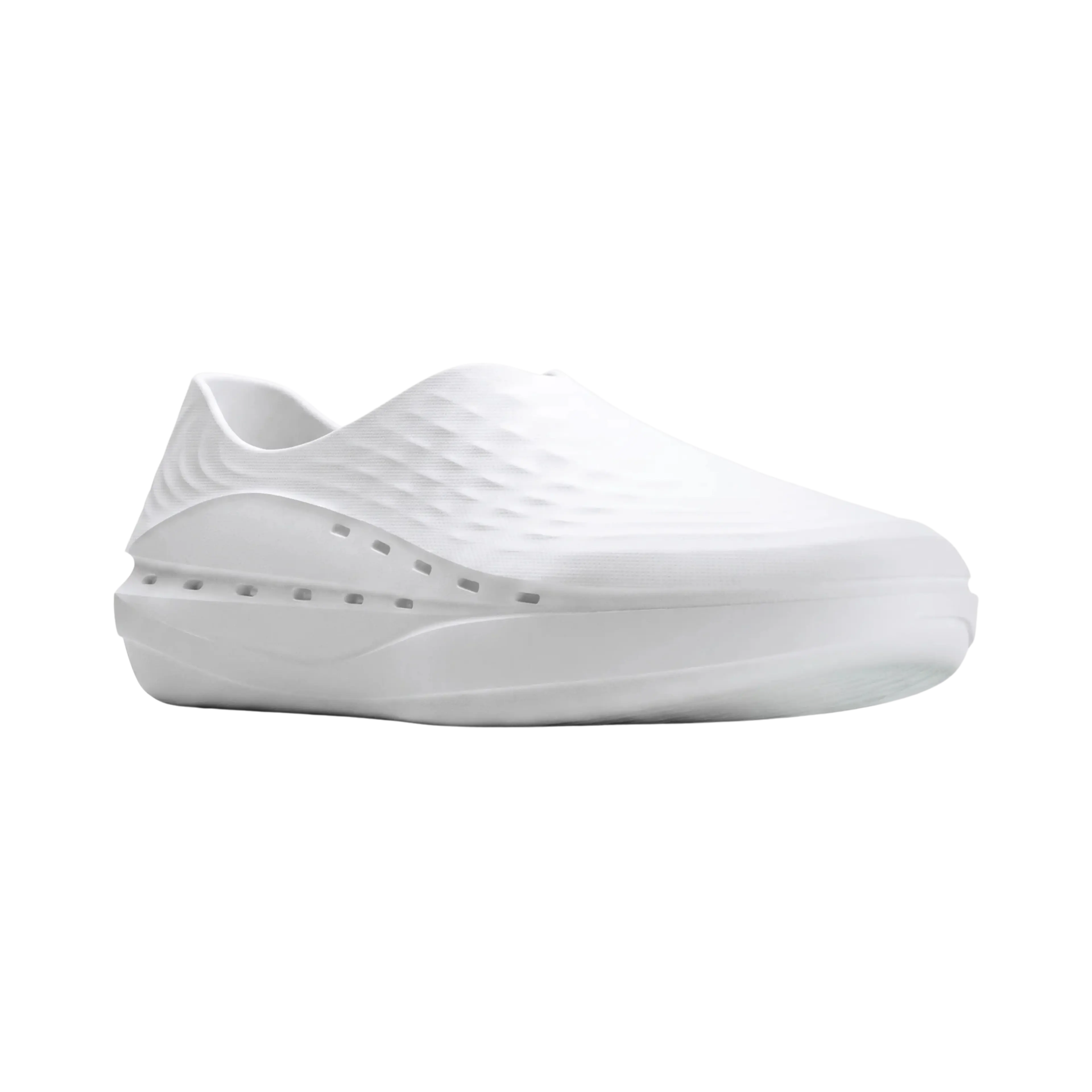 White slip-on shoe with a textured upper and perforated sides.