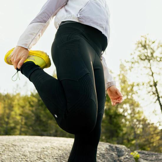 Woman stretching wearing Stoko leggings