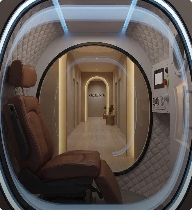 View from inside a futuristic pod with a brown leather chair, looking out to a hallway that says "Ultimate Longevity Center."