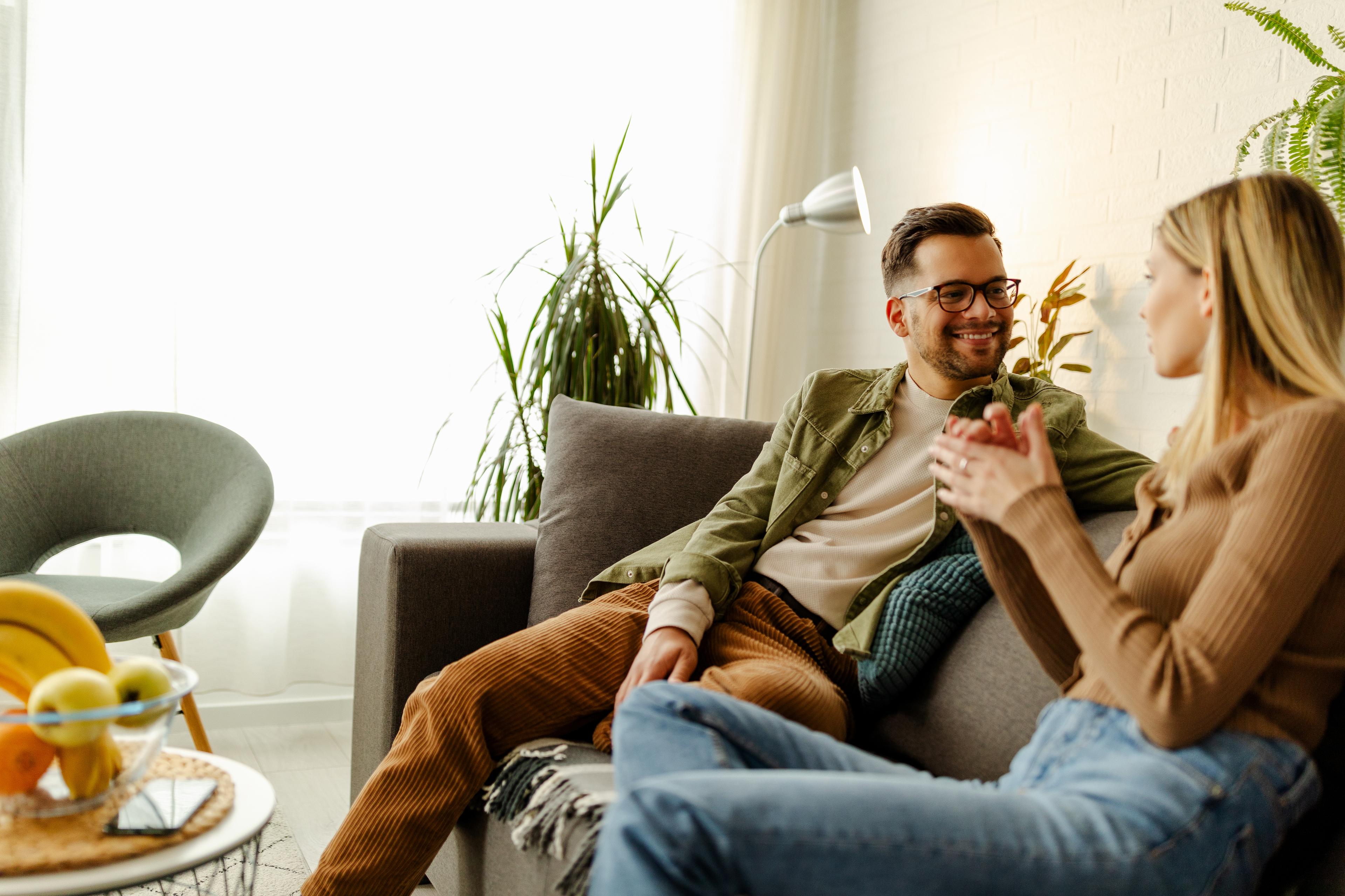 Couple sitting on the couch chatting