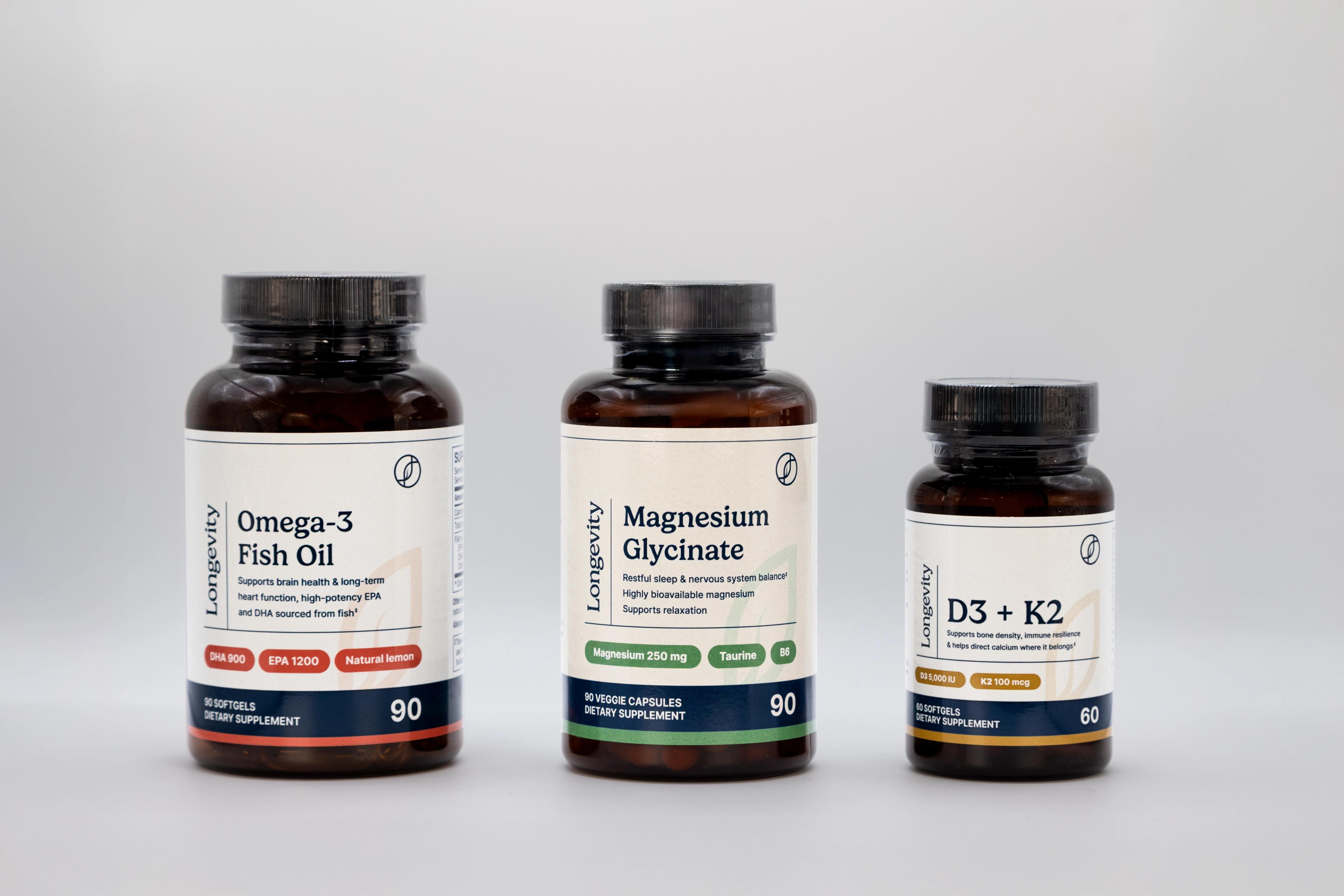 Three bottles of Longevity supplements: Omega-3 Fish Oil, Magnesium Glycinate, and D3+K2.