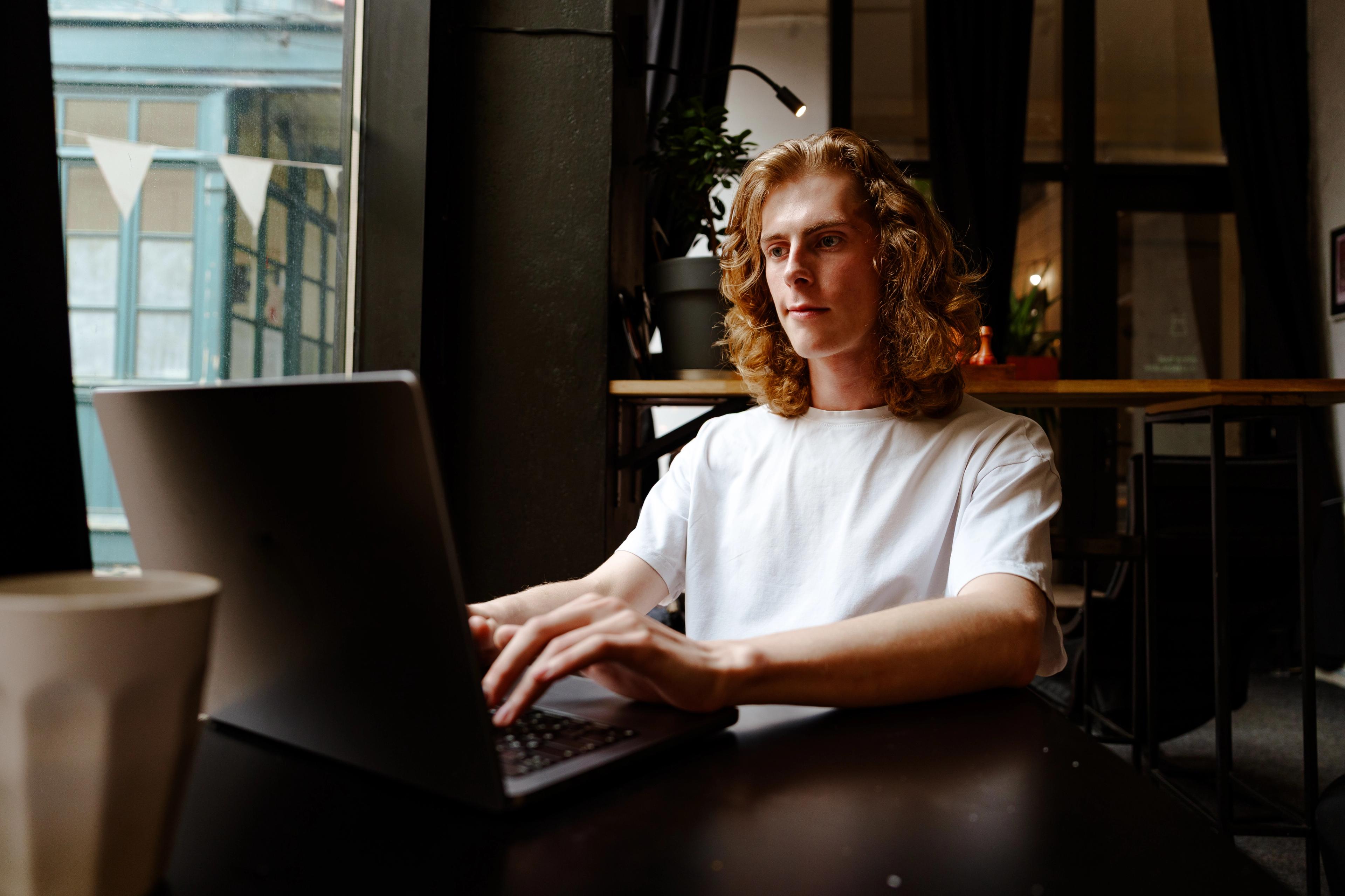 Man working in a coffee shop on his laptop
