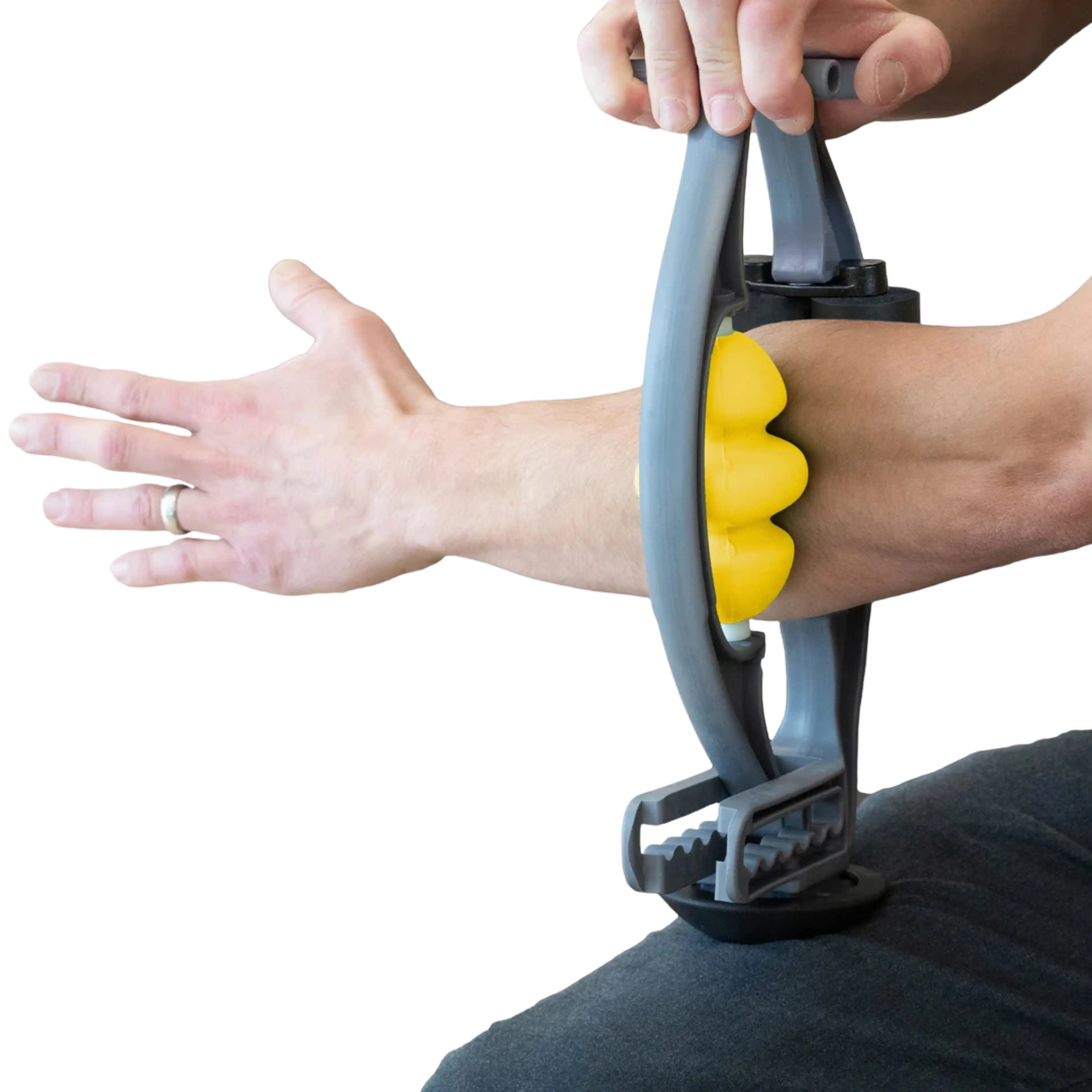 A person uses a grey and yellow self-massage tool on their forearm.