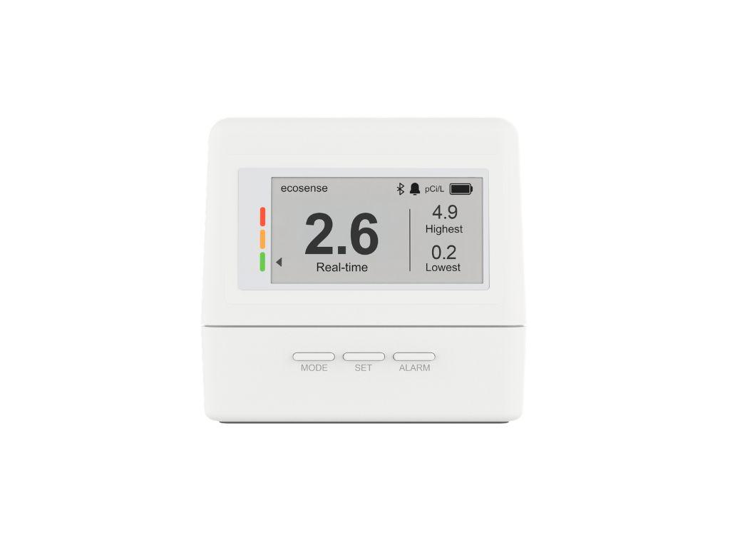 A white ecosense radon detector displaying a real-time reading of 2.6 pCi/L, with highest 4.9 and lowest 0.2.