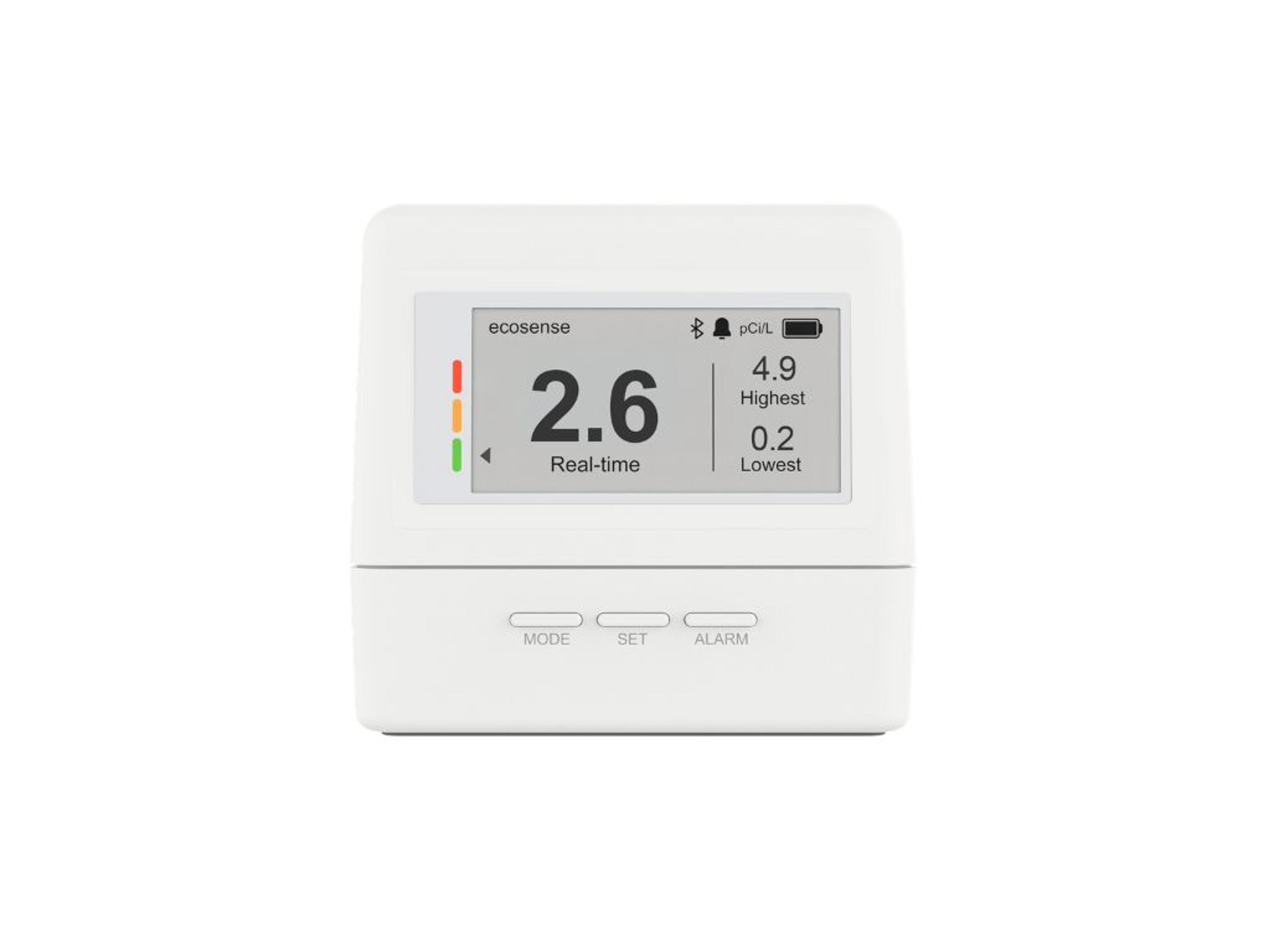 A white ecosense radon detector displaying a real-time reading of 2.6 pCi/L, with highest 4.9 and lowest 0.2.