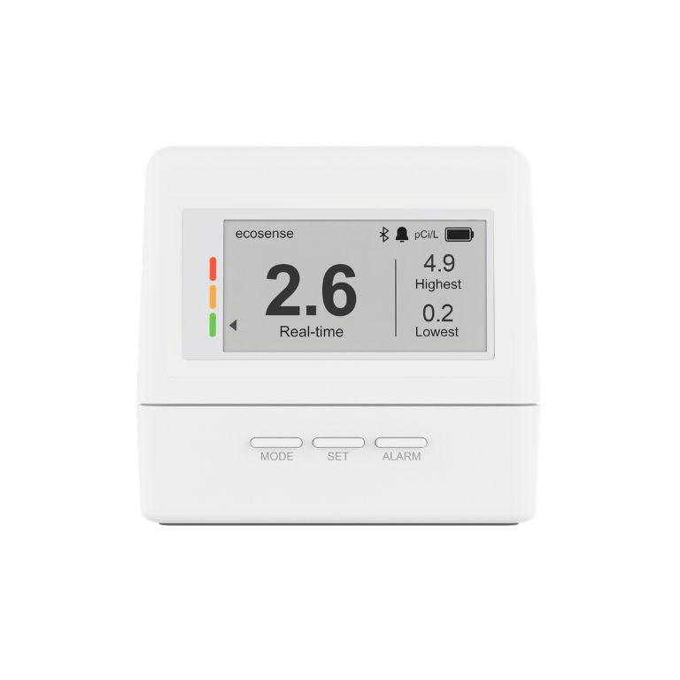 A white ecosense radon detector displaying a real-time reading of 2.6 pCi/L, with highest 4.9 and lowest 0.2.