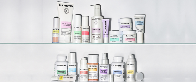 An assortment of CLEARSTEM skincare products with white packaging and colorful labels displayed on two shelves.