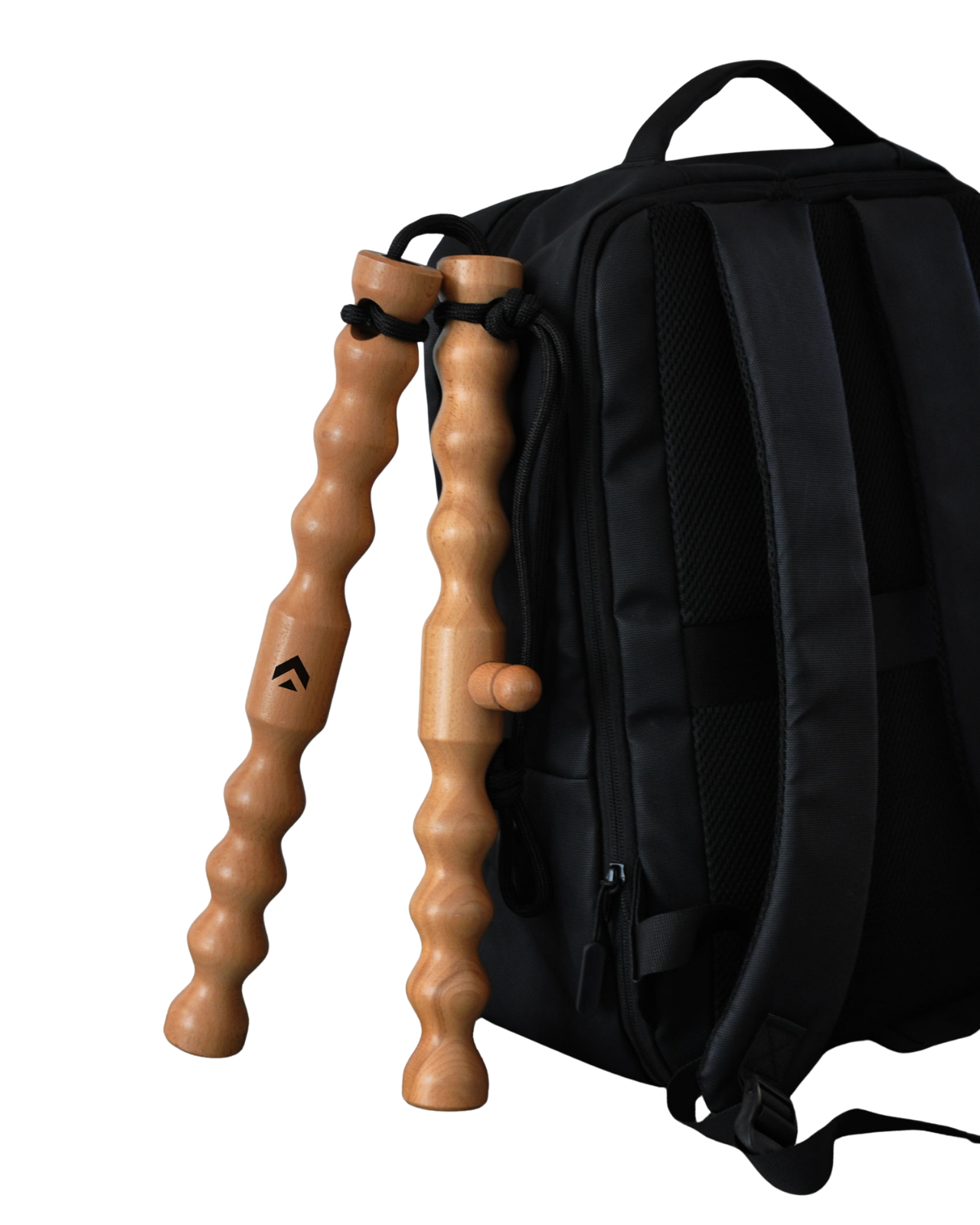 Two wavy wooden jump rope handles hanging from a black backpack.
