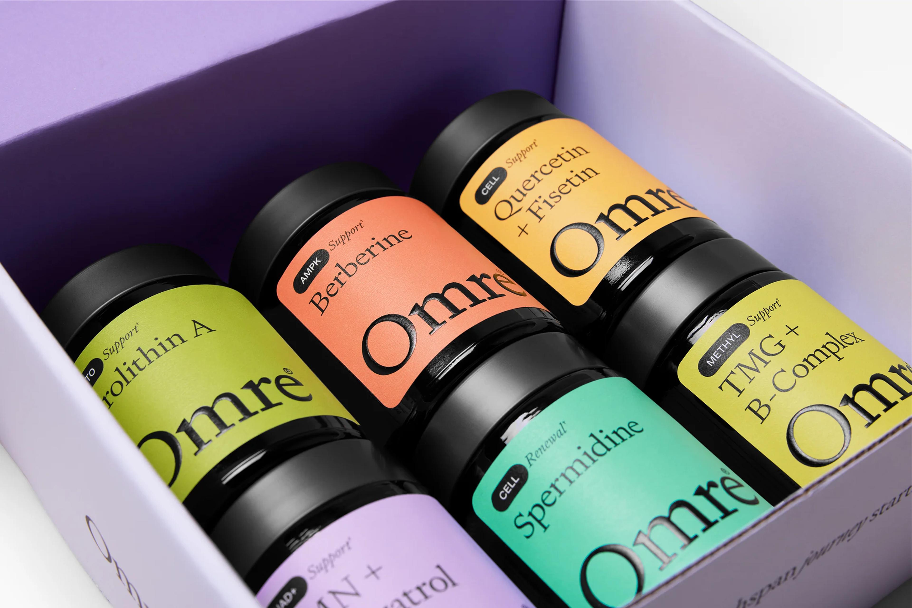 Six Omre supplement bottles with colorful labels in an open purple box.