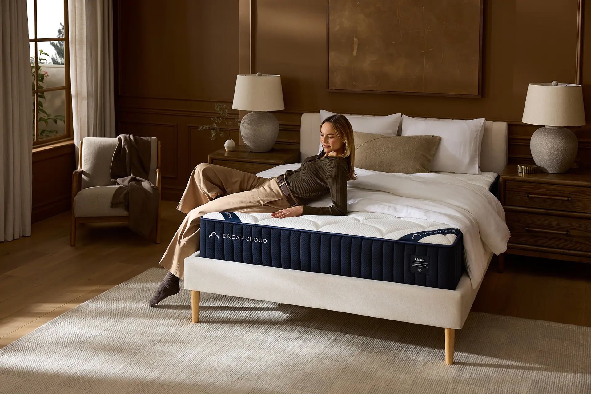 Woman laying on edge of DreamCloud mattress