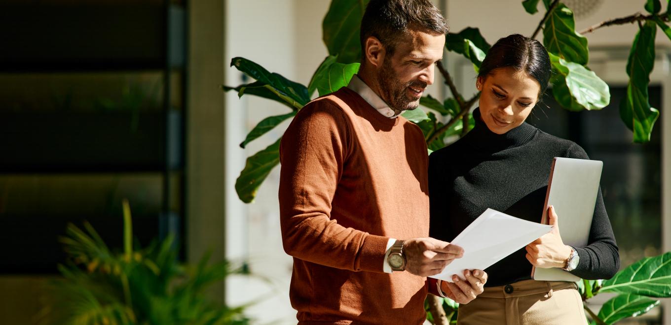 Two coworkers reviewing their health insurance options