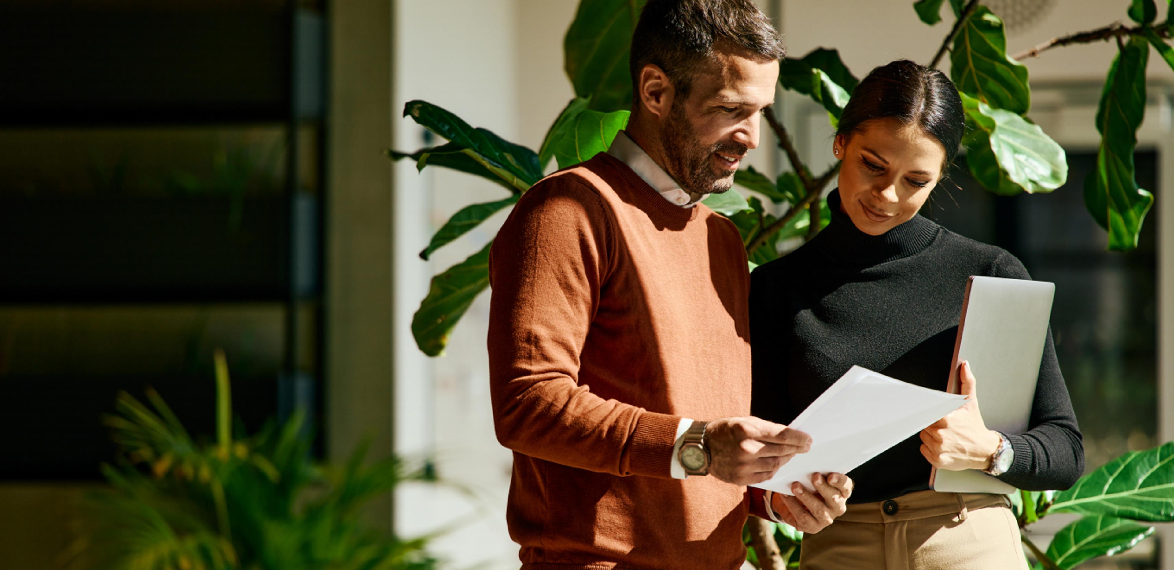 Two coworkers reviewing their health insurance options