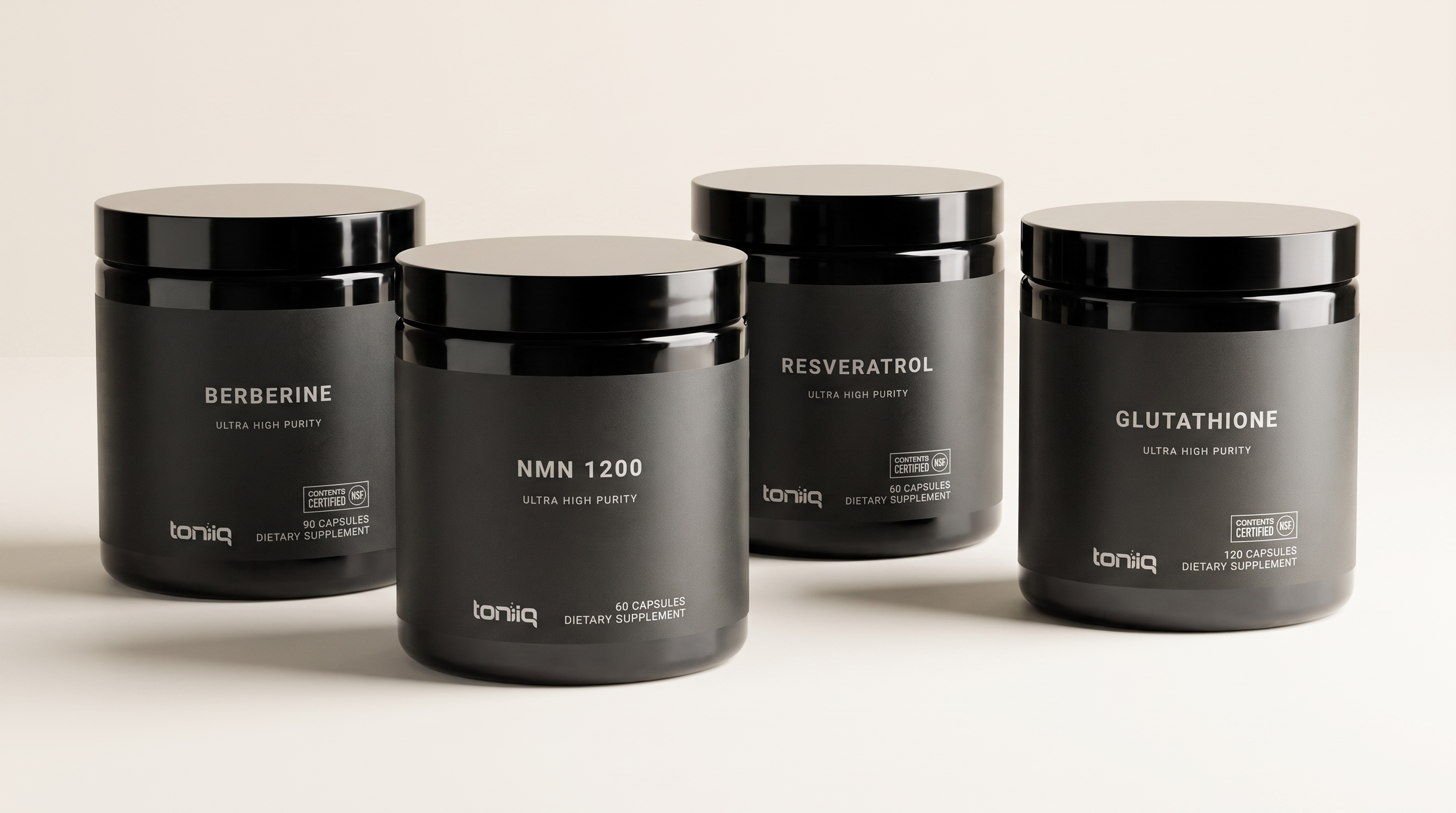 Four black Toniq supplement containers labeled Berberine, NMN 1200, Resveratrol, and Glutathione.