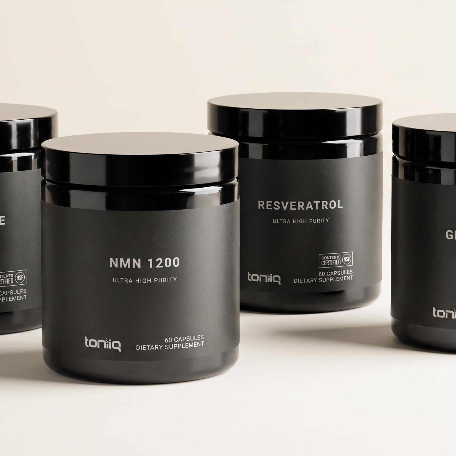 Four black Toniq supplement containers labeled Berberine, NMN 1200, Resveratrol, and Glutathione.