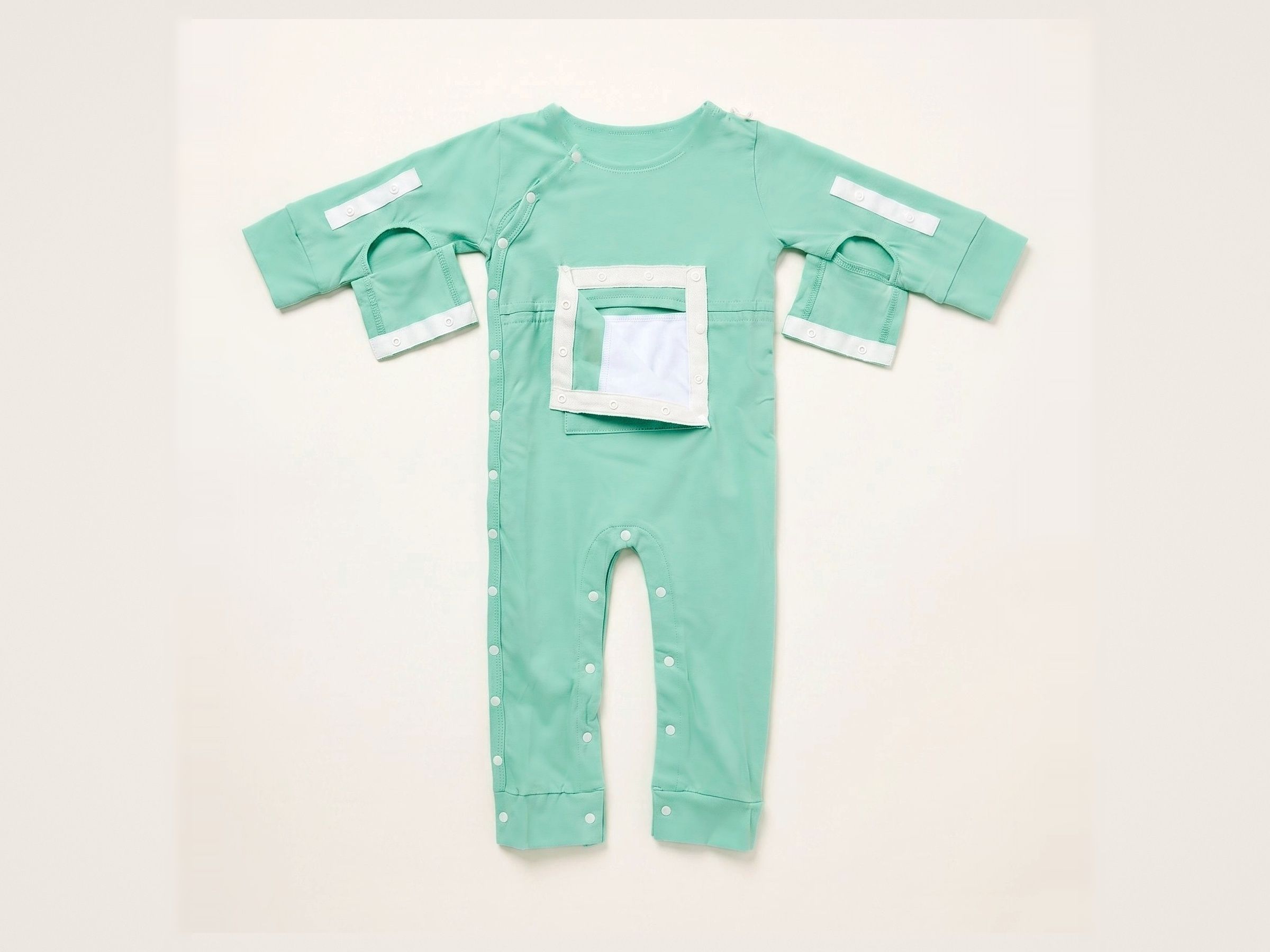 Mint green baby one-piece with full-length snaps, a rectangular chest opening, and open sleeves with white velcro tabs.