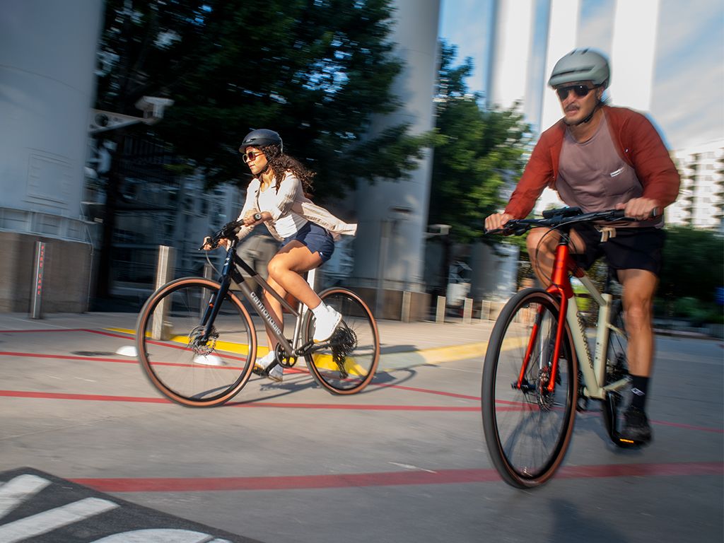 Man and woman cycling with motion blur.