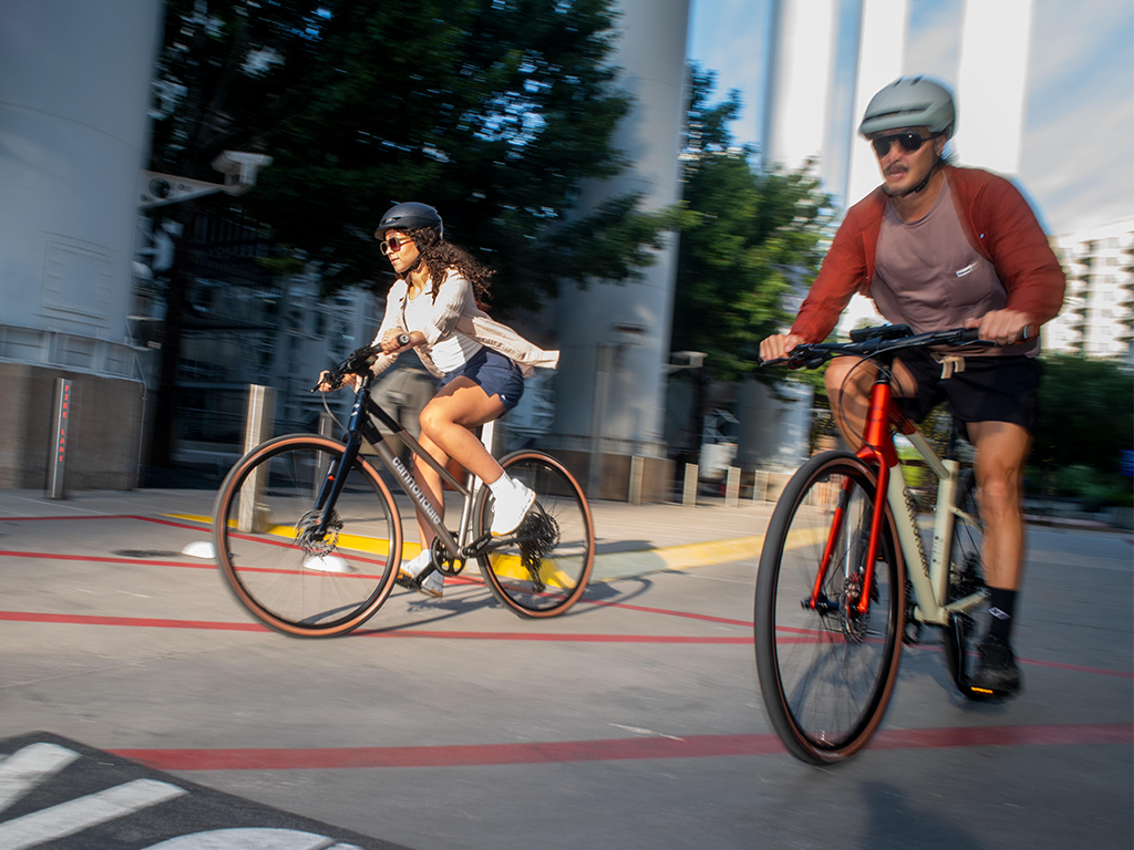 Man and woman cycling with motion blur.