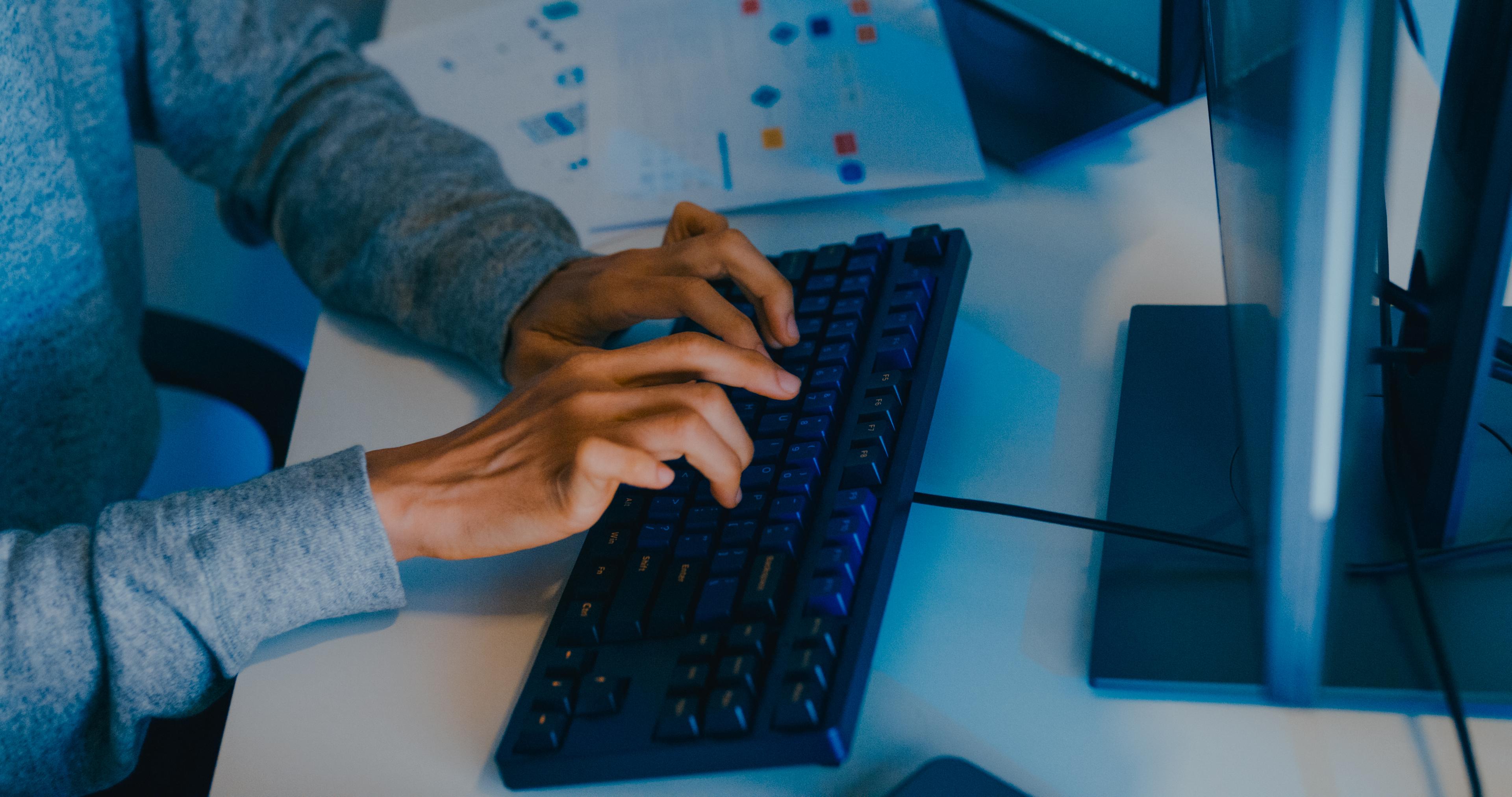 Person typing on a keyboard