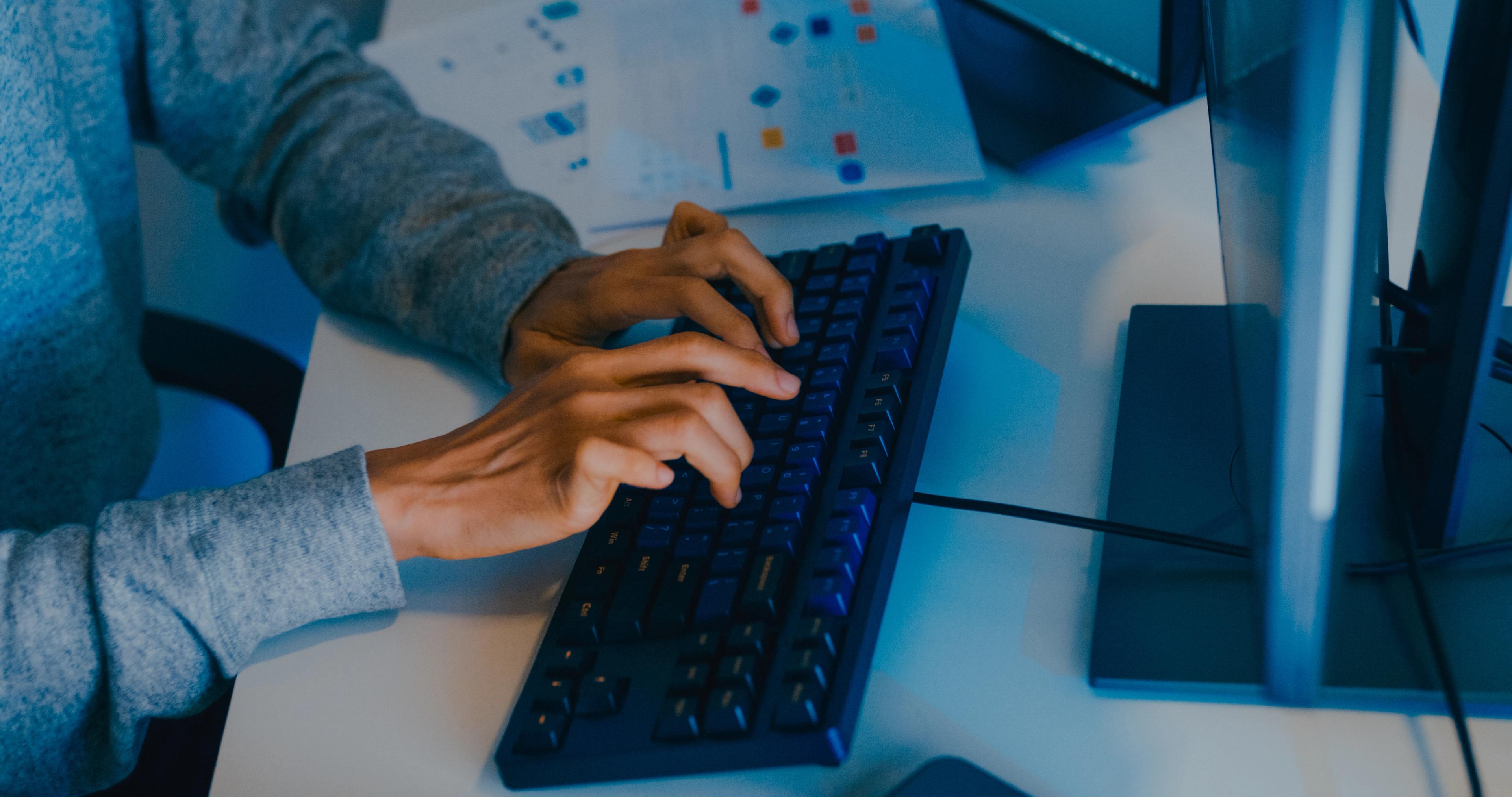 Person typing on a keyboard