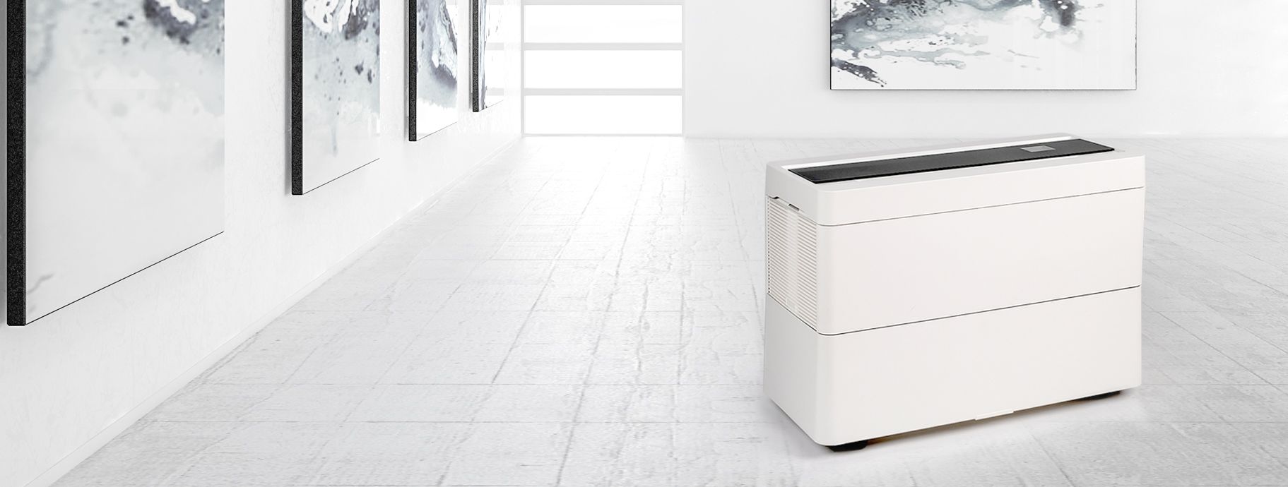Sleek white device with a black top panel in a modern minimalist room.