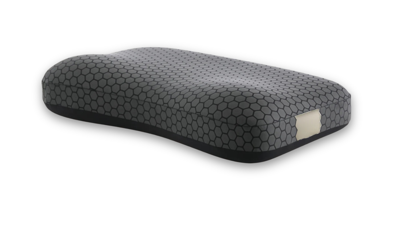 Grey contoured pillow with hexagonal pattern, revealing beige foam interior on the side.