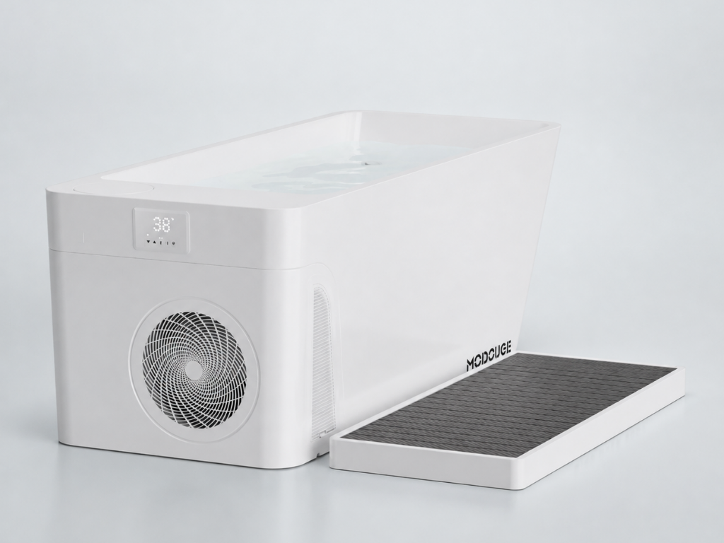 A white MODCUBE cold plunge tub filled with water, displaying "38°" on its screen, with a dark gray textured mat next to it.