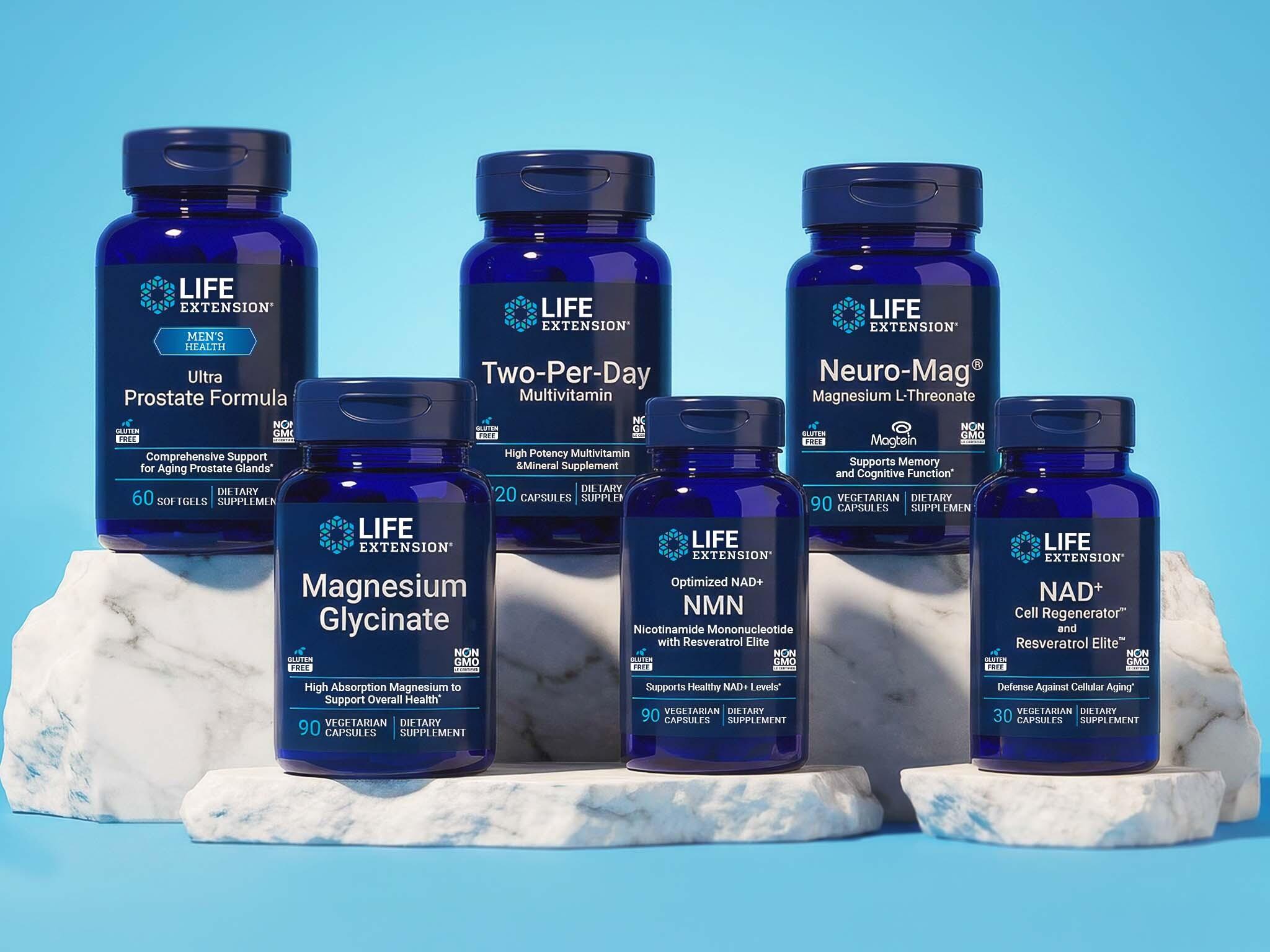 Six blue Life Extension supplement bottles, including Ultra Prostate Formula and Neuro-Mag, on white blocks against a blue background.