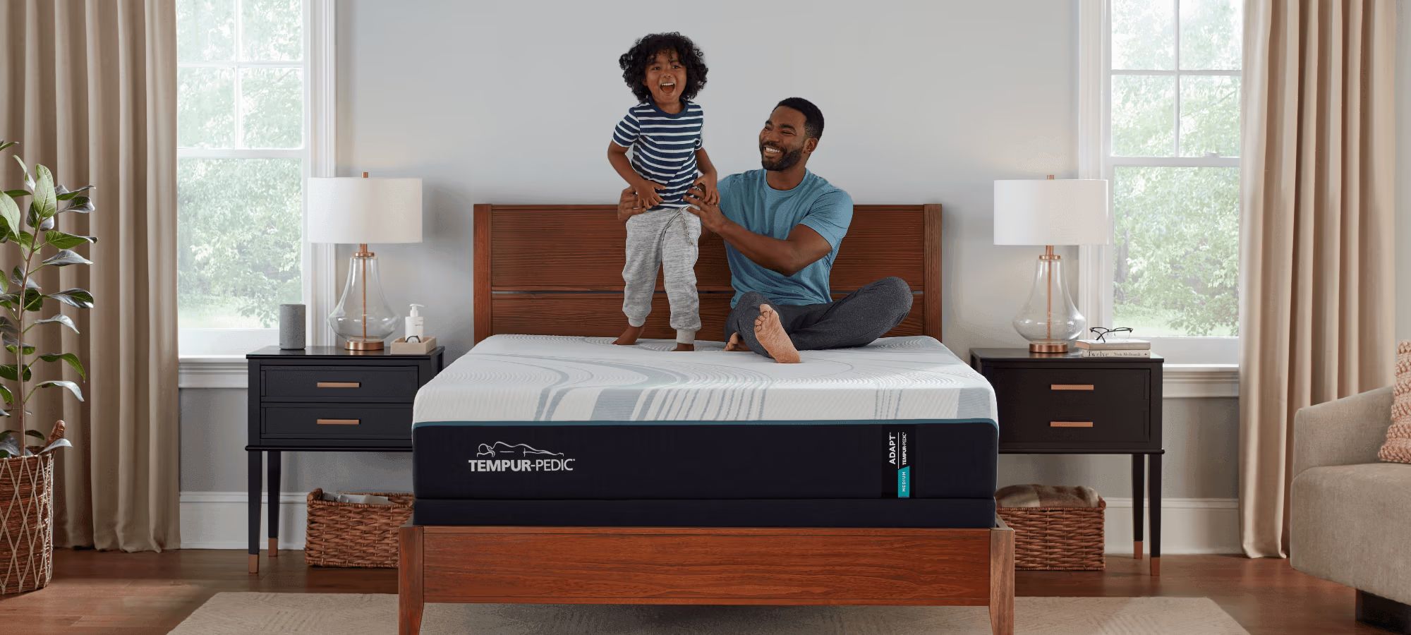 Child and father playing on a mattress