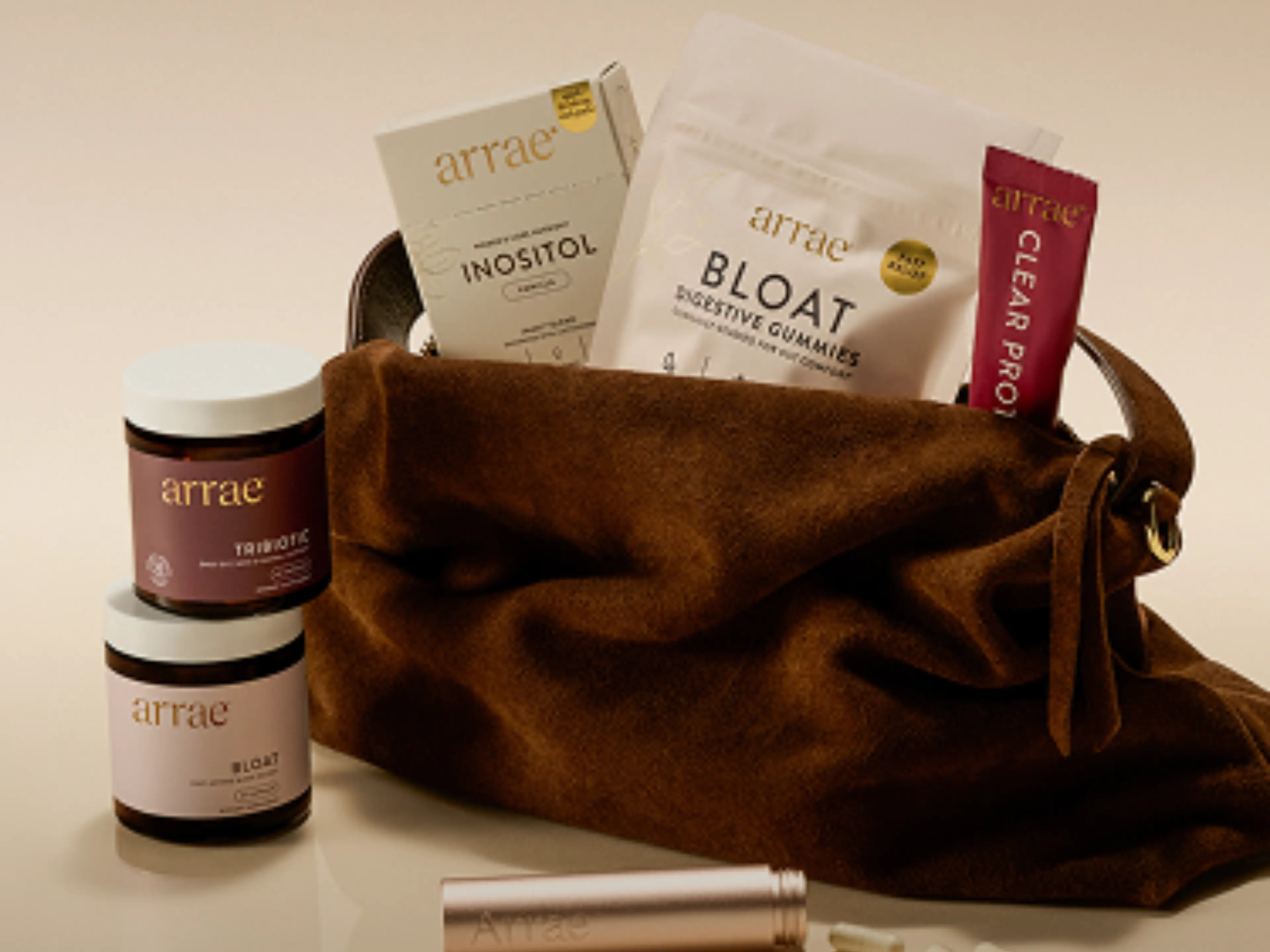 A brown bag filled with various Arrae health products, including supplements and gummies.