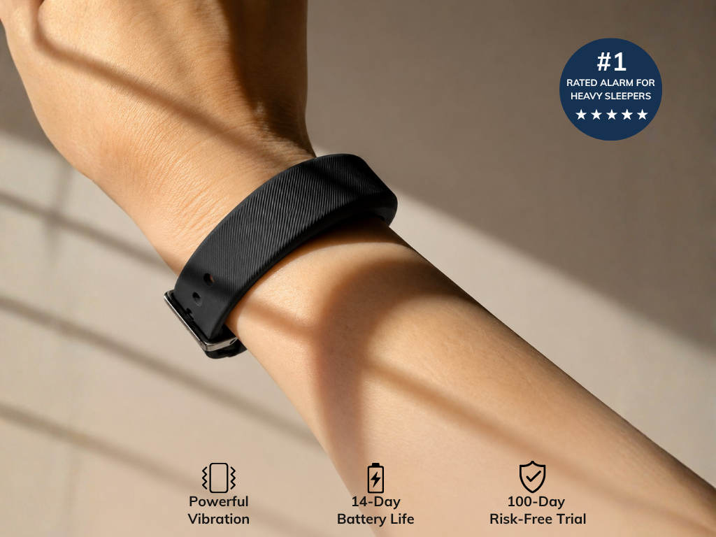 A person's arm wearing a black vibrating alarm wristband. Text highlights: #1 rated for heavy sleepers, powerful vibration, 14-day battery life, and 100-day risk-free trial.