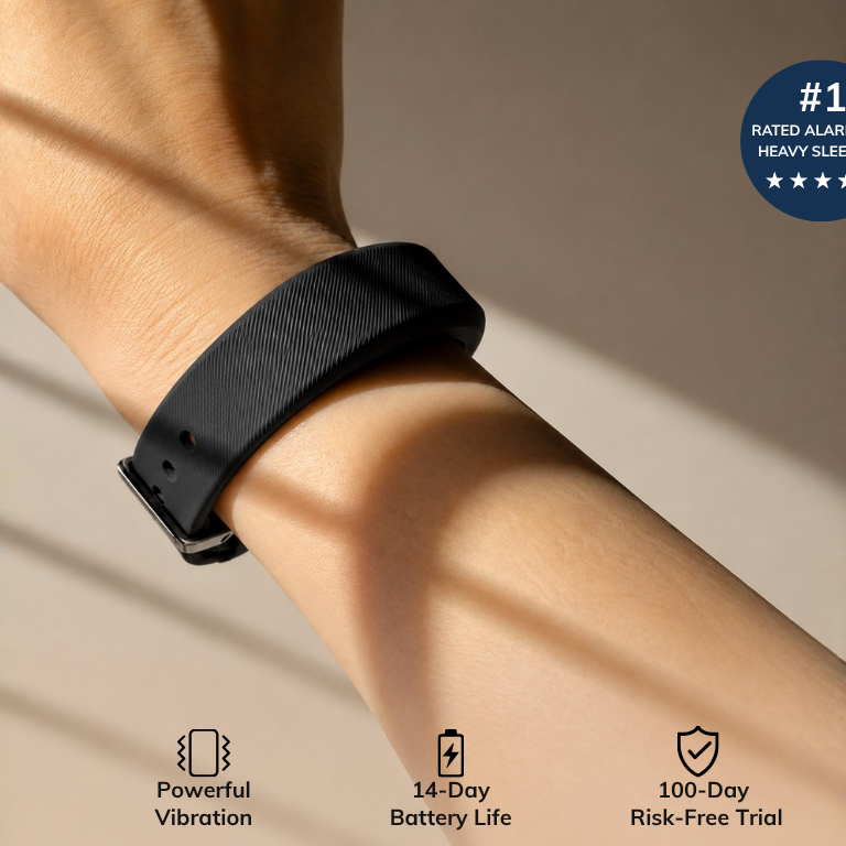 A person's arm wearing a black vibrating alarm wristband. Text highlights: #1 rated for heavy sleepers, powerful vibration, 14-day battery life, and 100-day risk-free trial.