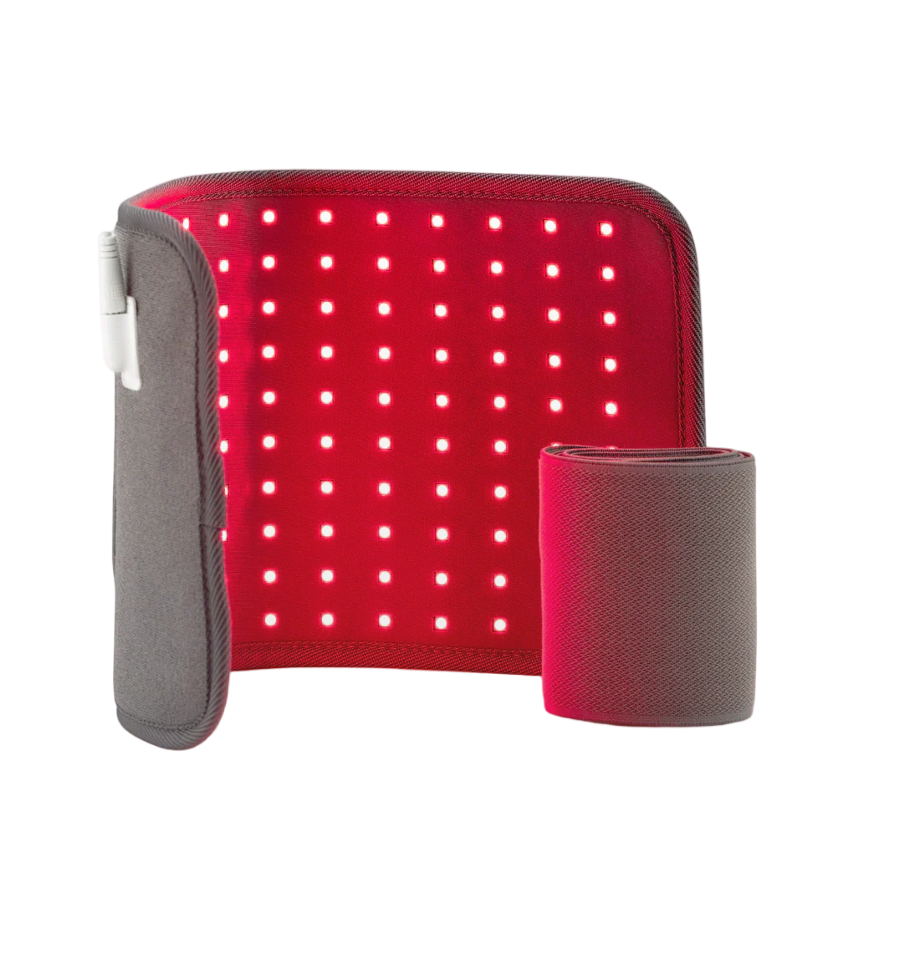 Red light therapy pad glowing with red light