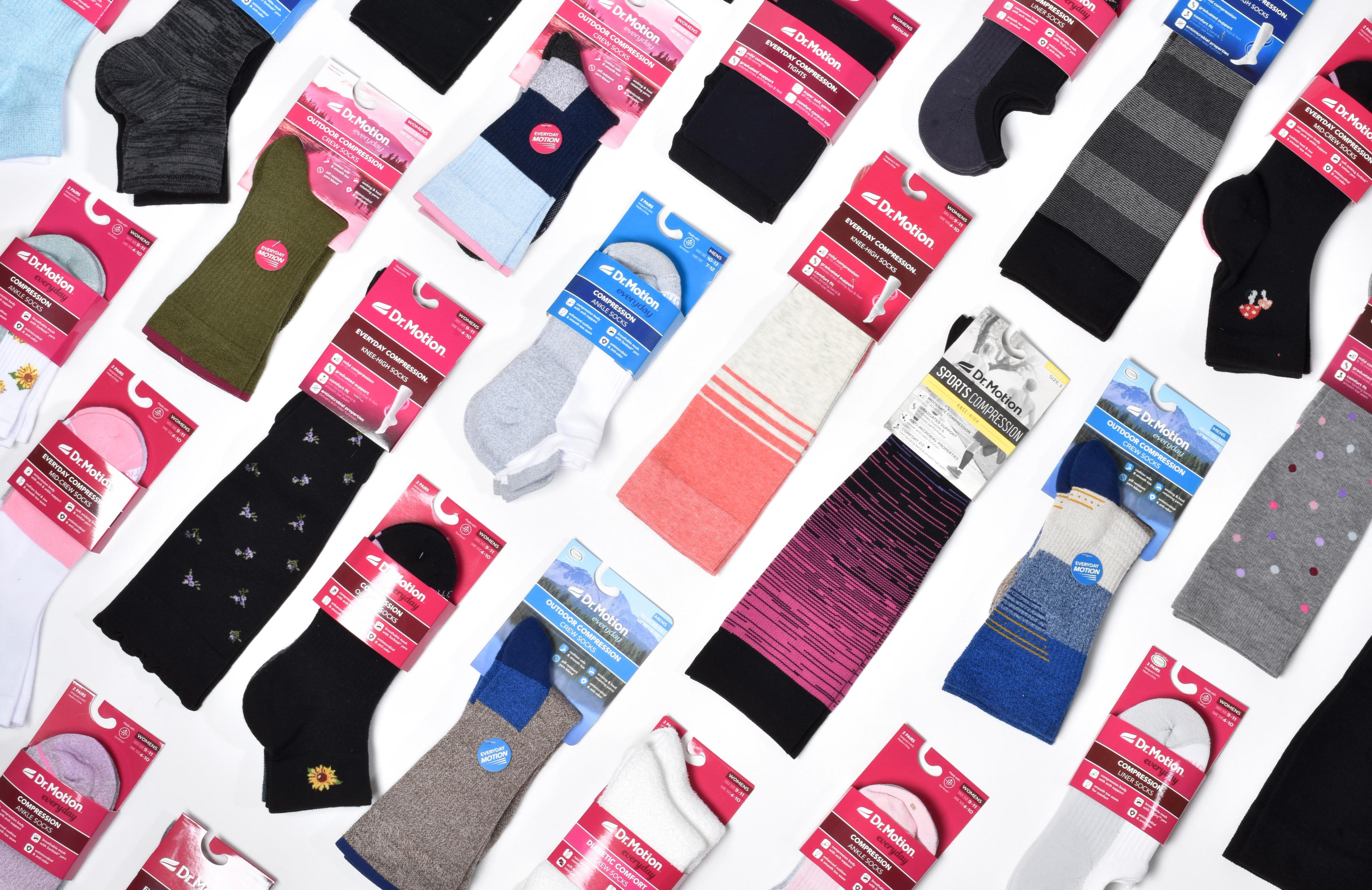 An array of Dr. Motion packaged socks in various colors and patterns on a white background.
