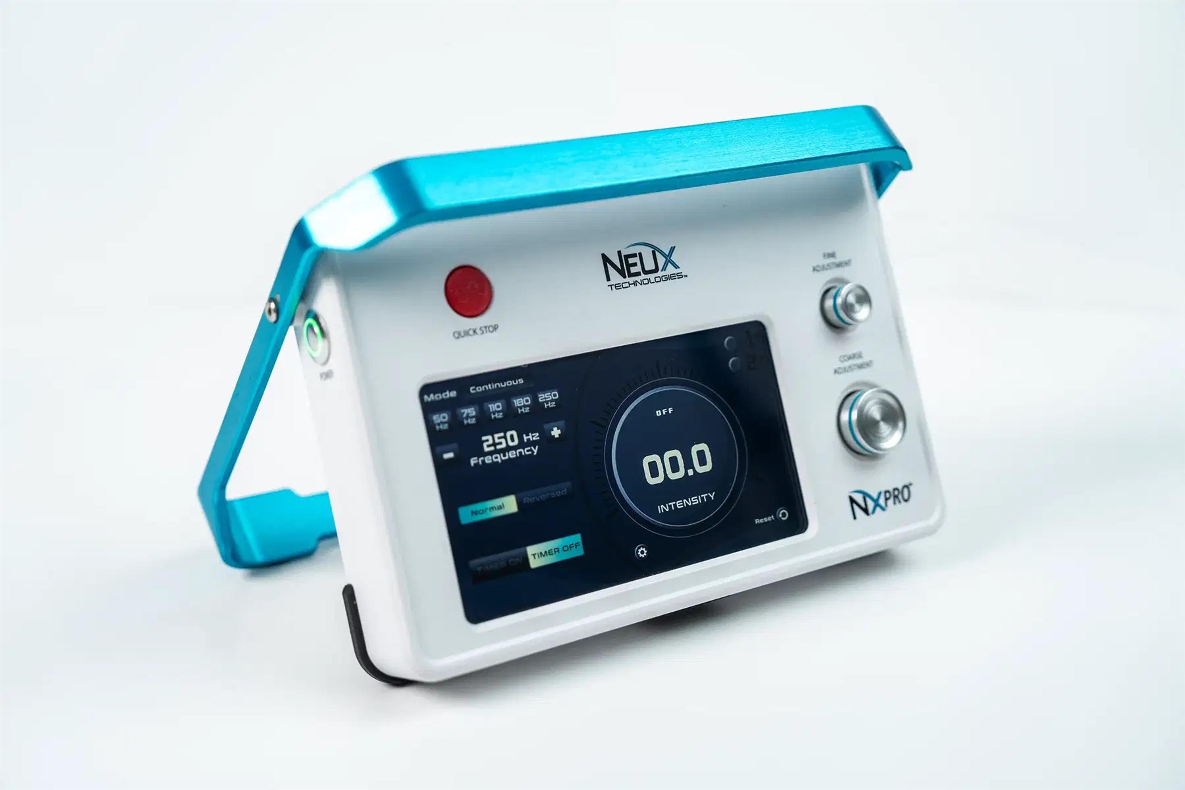 A white and blue Neux Technologies NXPRO medical therapy device with a digital screen showing frequency and intensity.