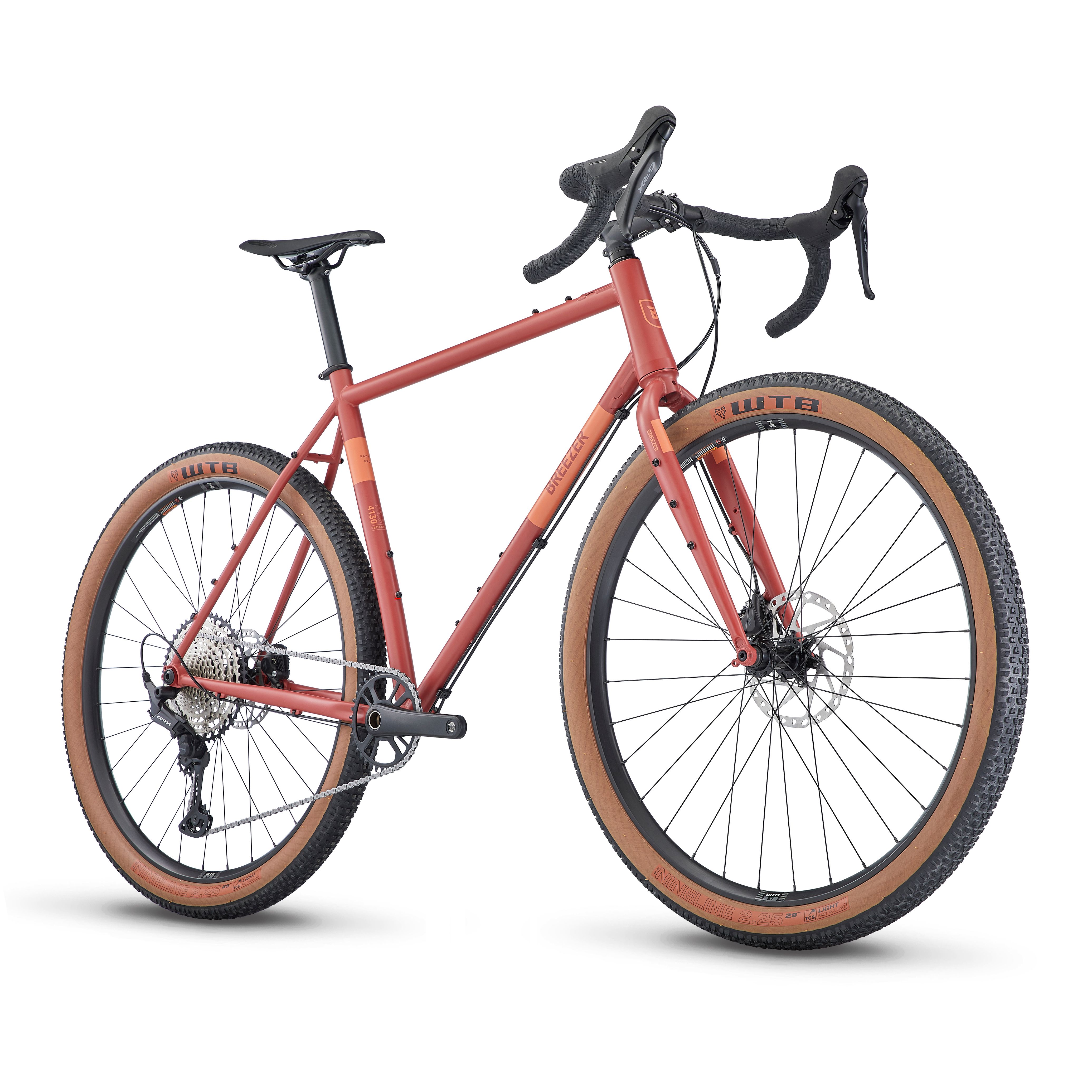 Blue Breezer gravel bike with drop handlebars and knobby tan-sidewall tires.