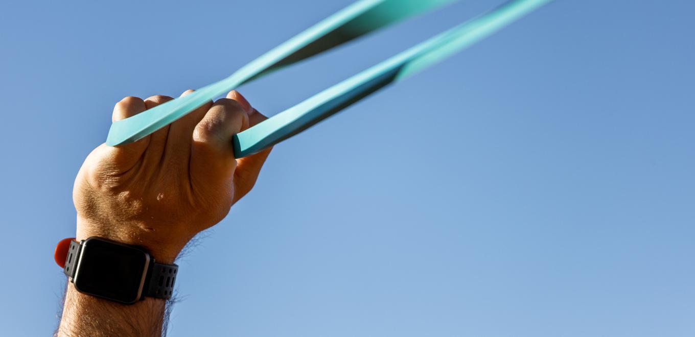 A person working out using resistance bands outside