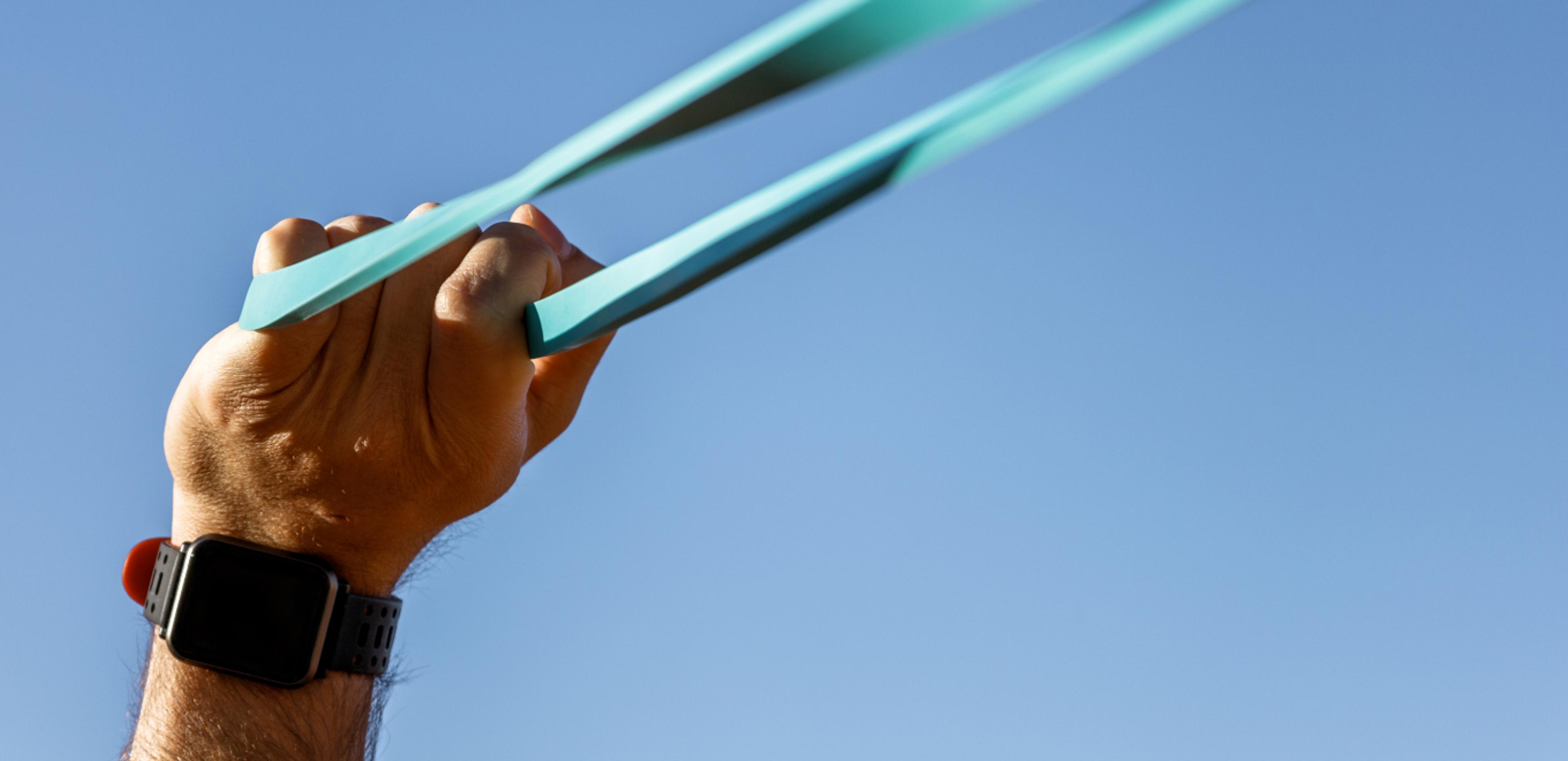 A person working out using resistance bands outside