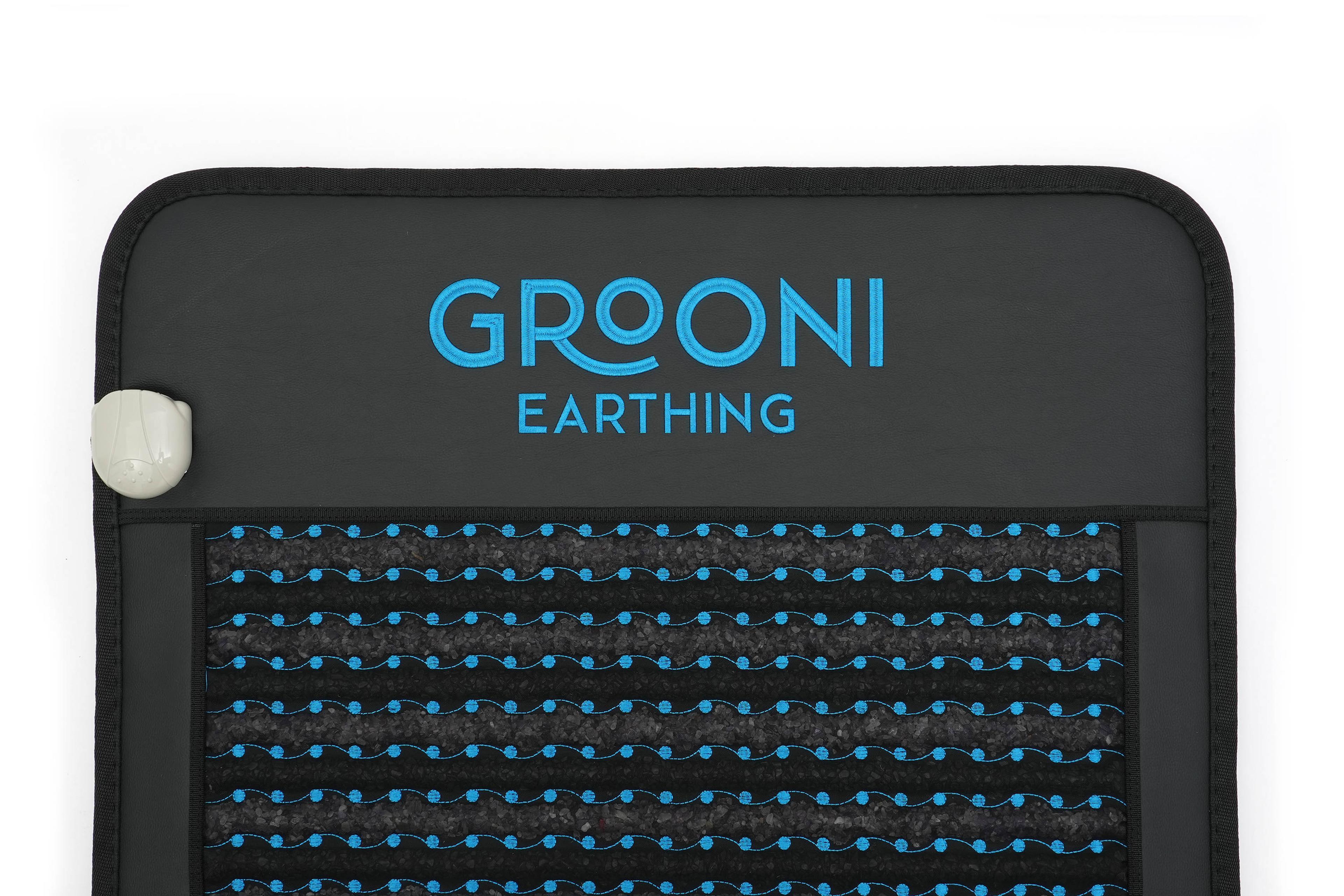 Dark grey mat with blue 'GROONI EARTHNG' text, wavy blue lines and dots, and a white connector.