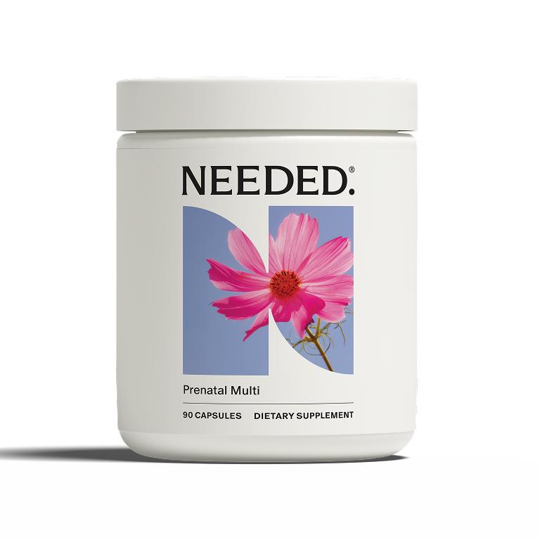 White jar of Needed. Prenatal Multi, a dietary supplement with 90 capsules. The label features a pink cosmos flower on a blue background, forming the letter 'N'.