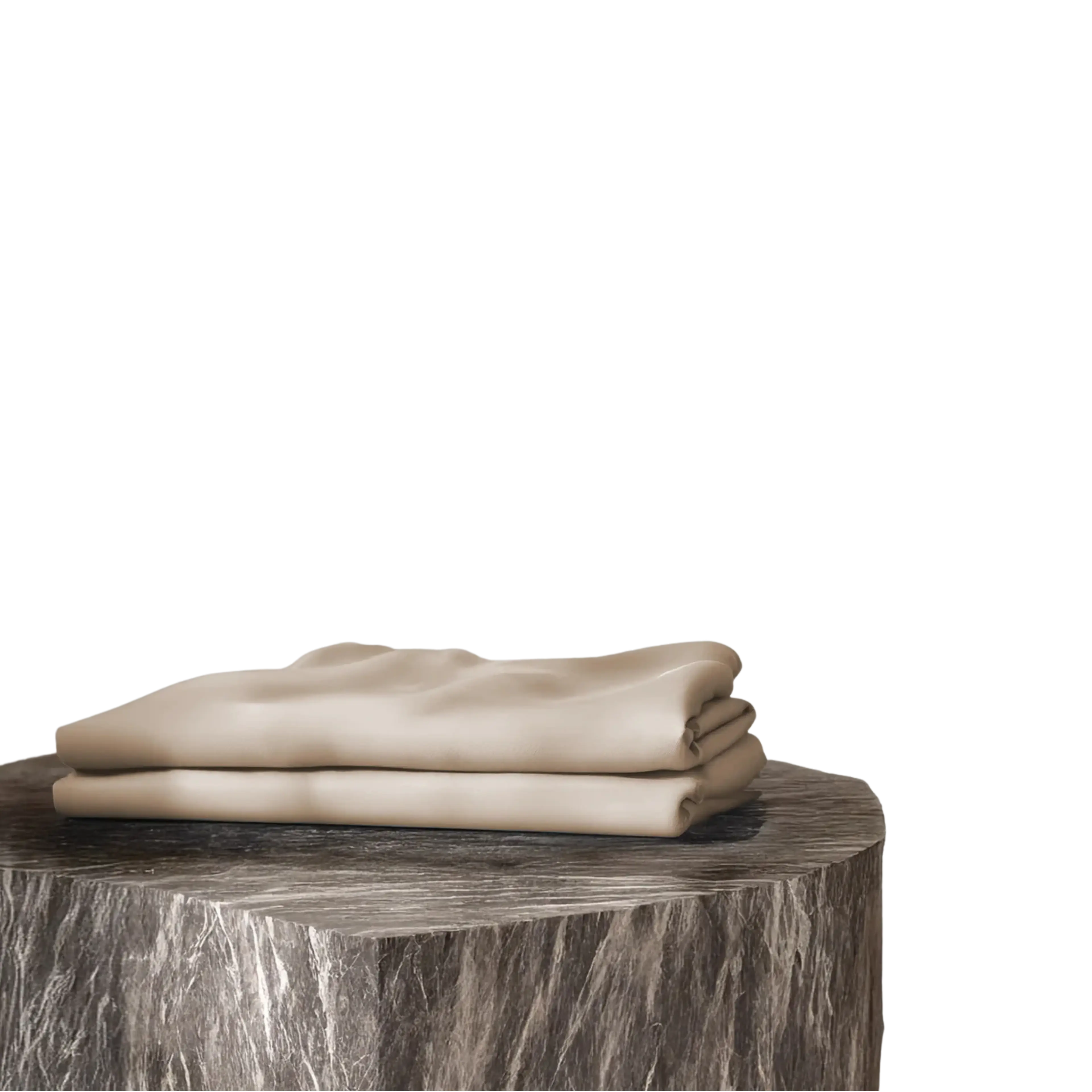 Two folded beige fabrics on a dark stone stand.
