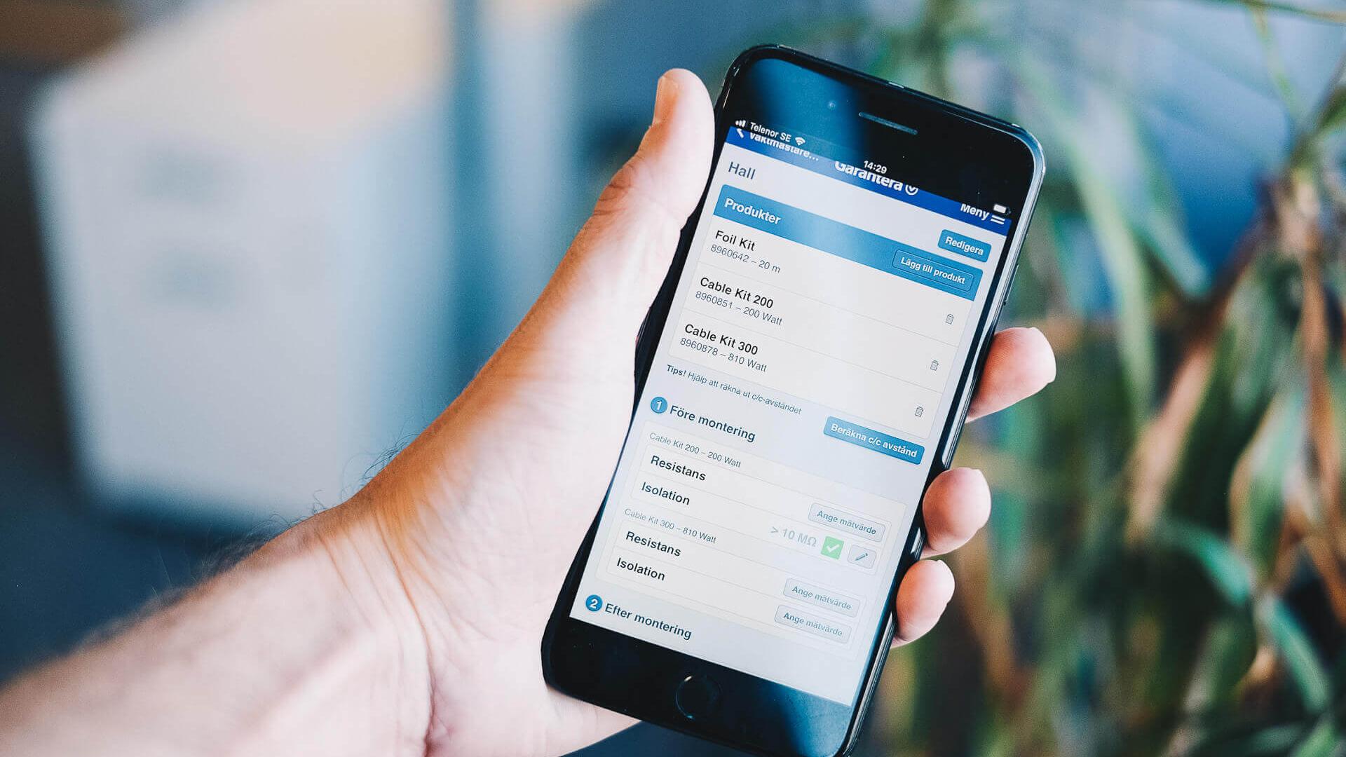 Bild på mobiltelefon med Garantera applikationen igång
