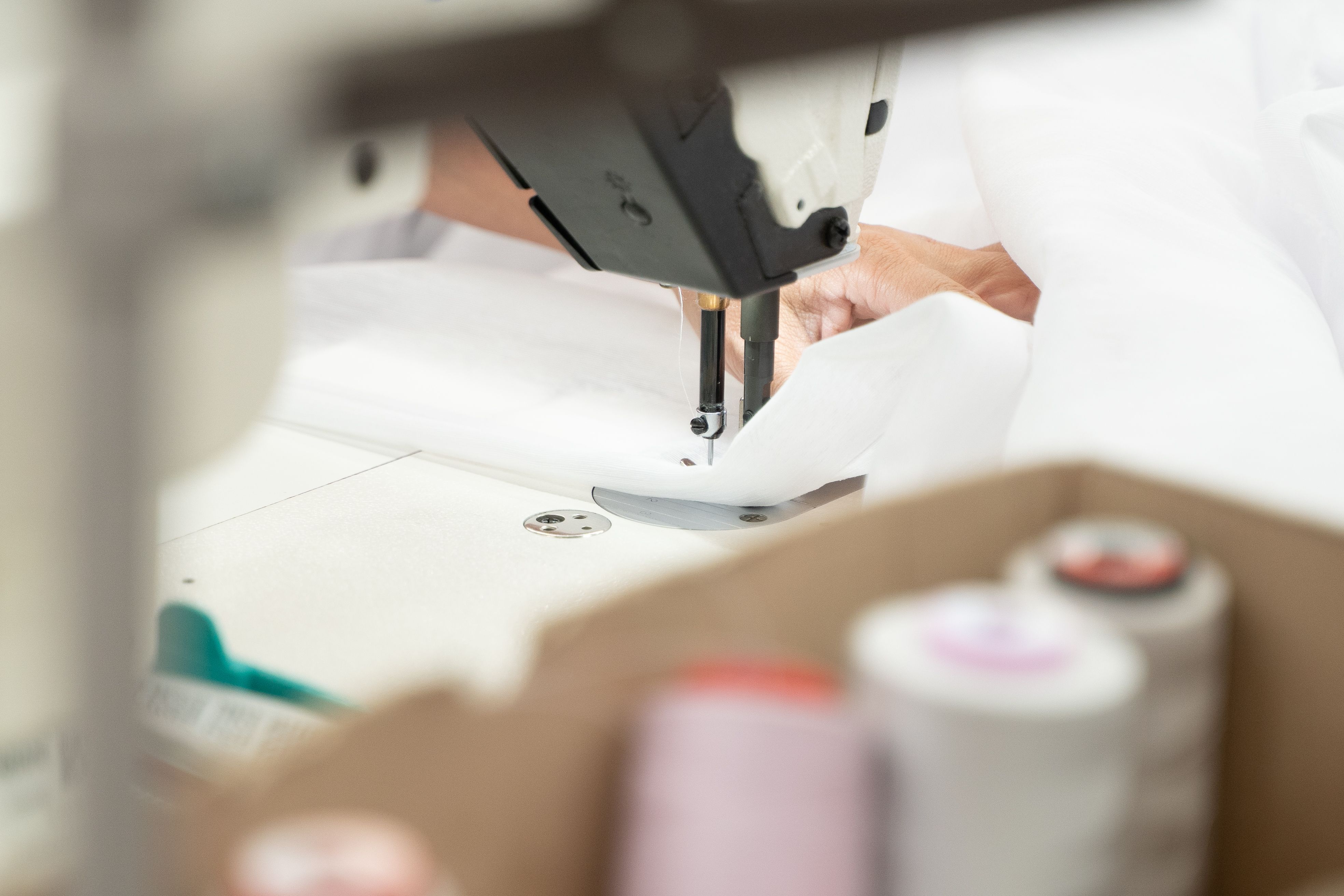 Curtain fabric being stitched in the workroom