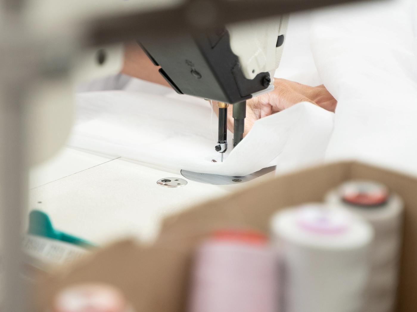 Curtain fabric being stitched in the workroom