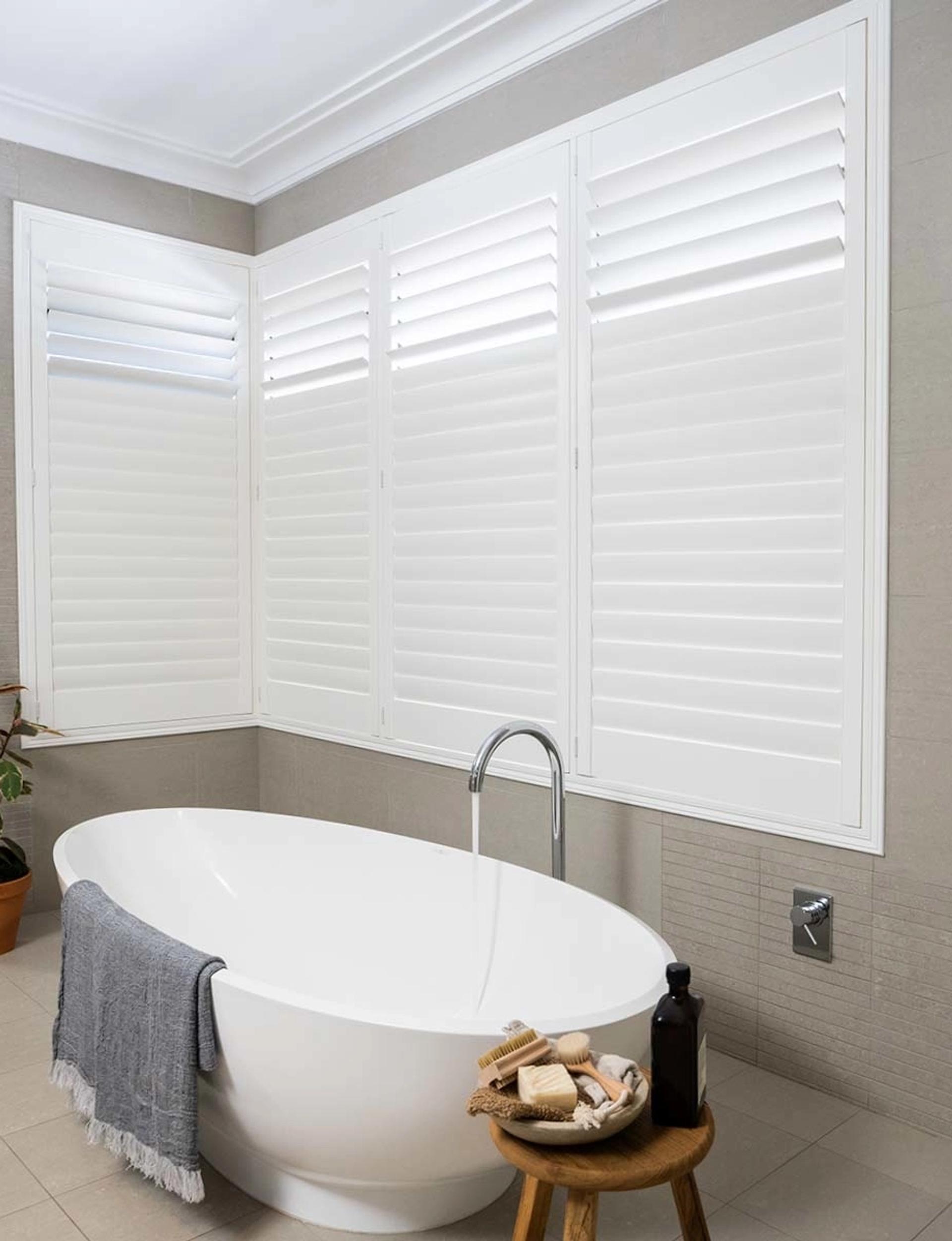 Norman Normandy hardwood shutters framing a warm family bedroom